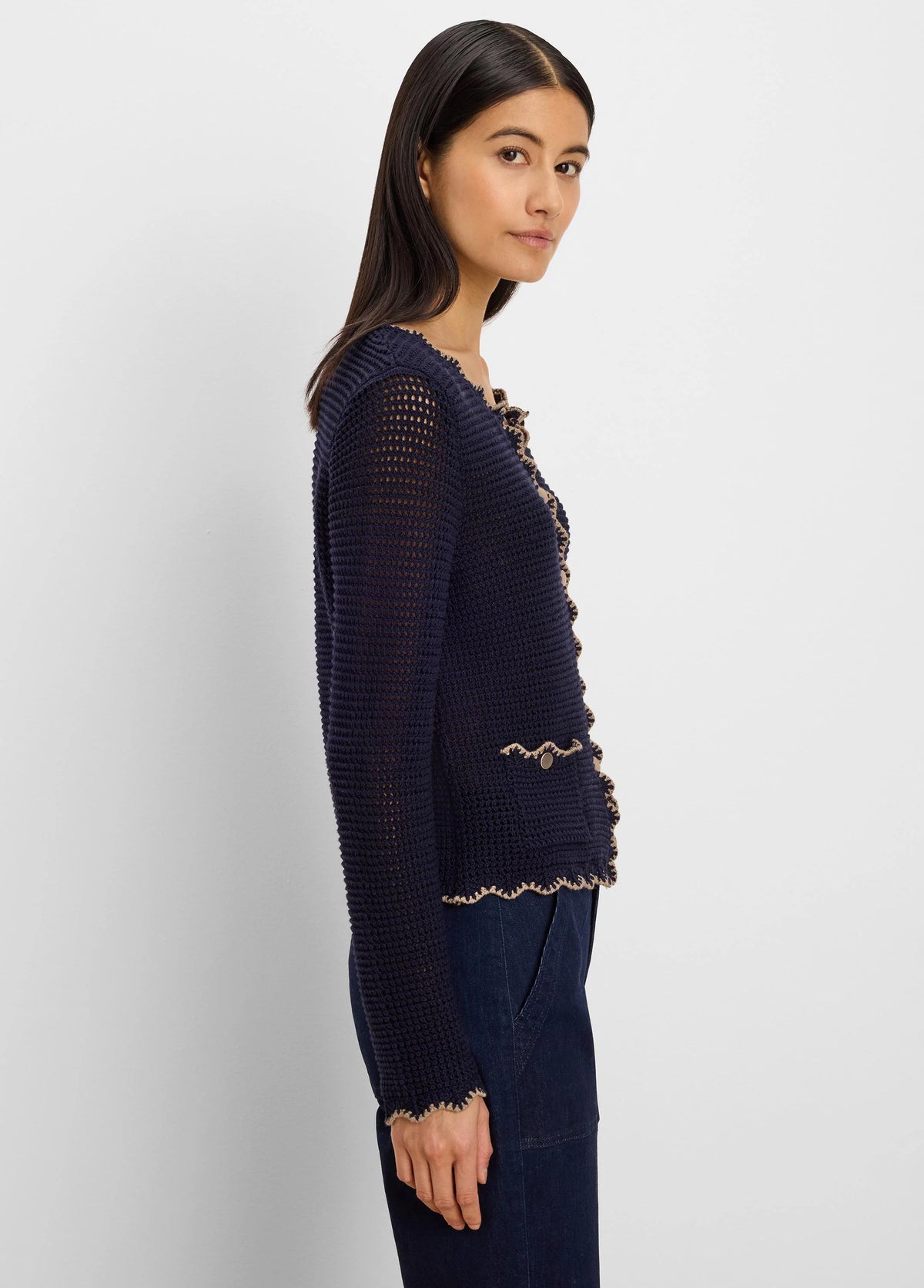 Navy open-knit cardigan with beige wavy trim on front, hem, cuffs, and faux pockets, plus small gold buttons.