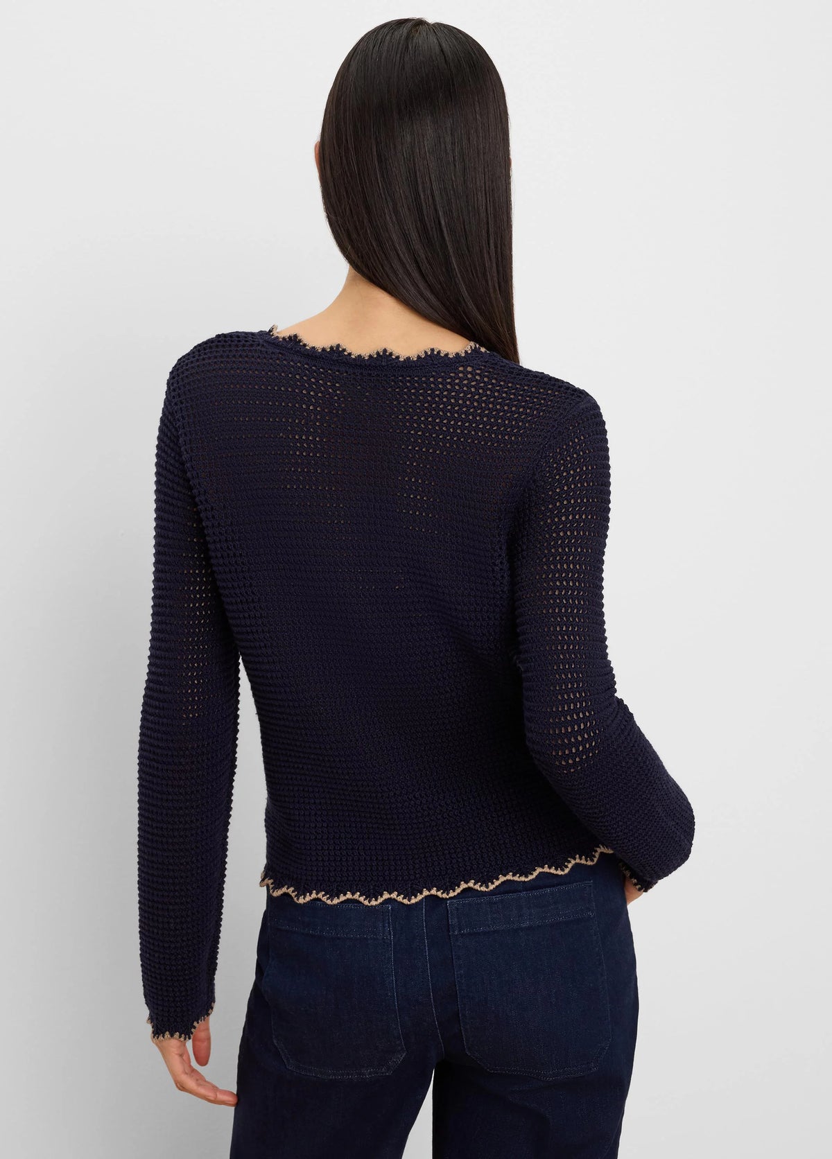 Navy blue mesh cardigan with scalloped tan trim at neckline, cuffs, and hem. Open knit, cropped.