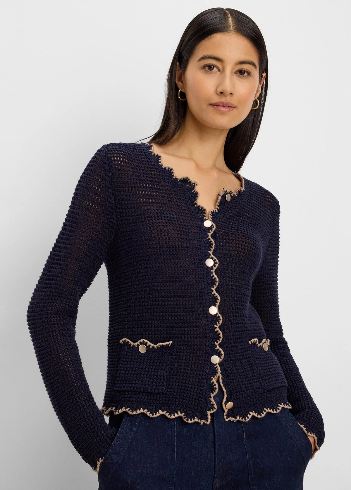 Navy blue mesh cardigan with scalloped tan trim, gold buttons, and front patch pockets.