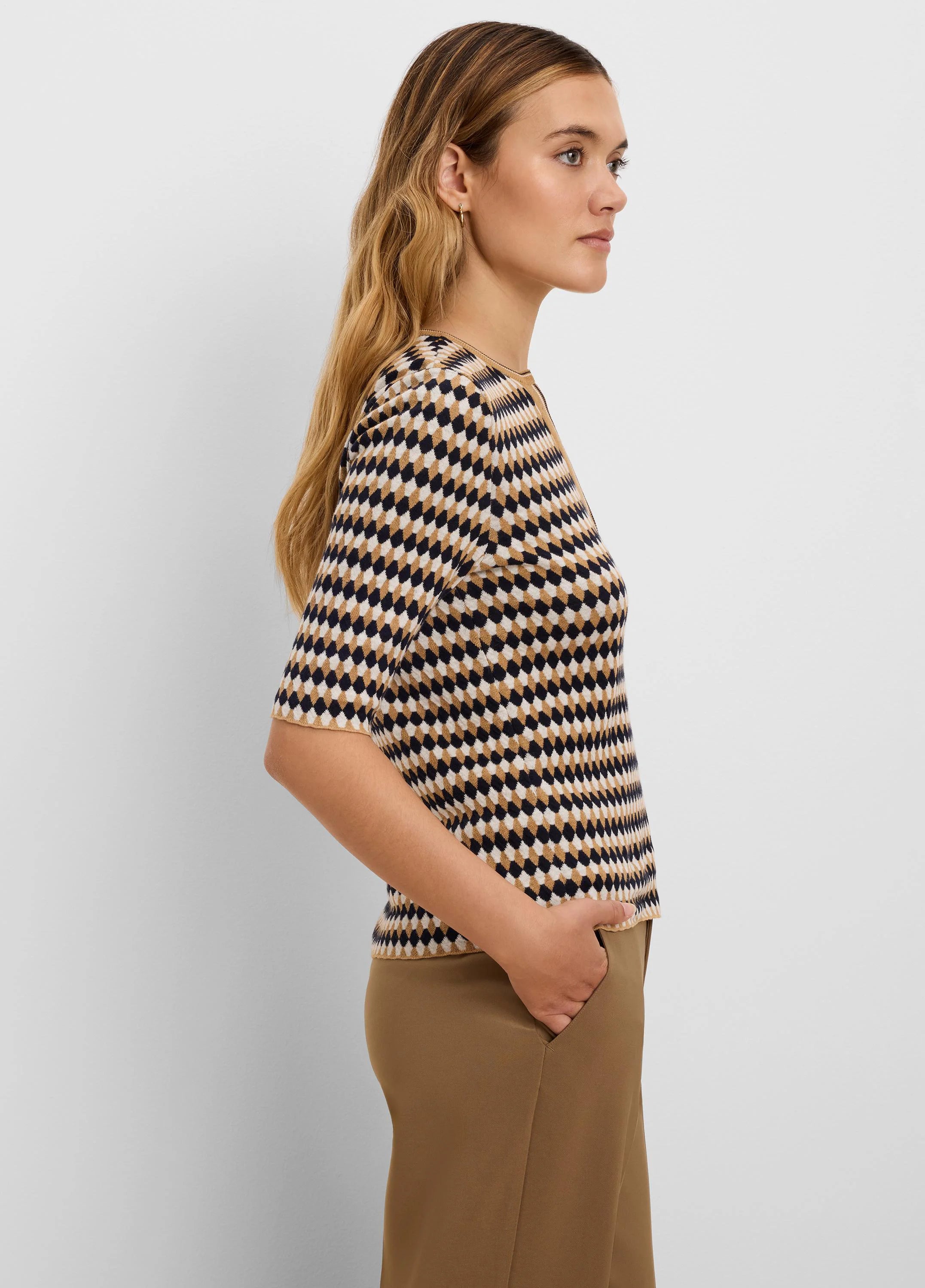 Angled jacquard sweater with navy, tan, and cream geometric pattern, round neck, and elbow sleeves.