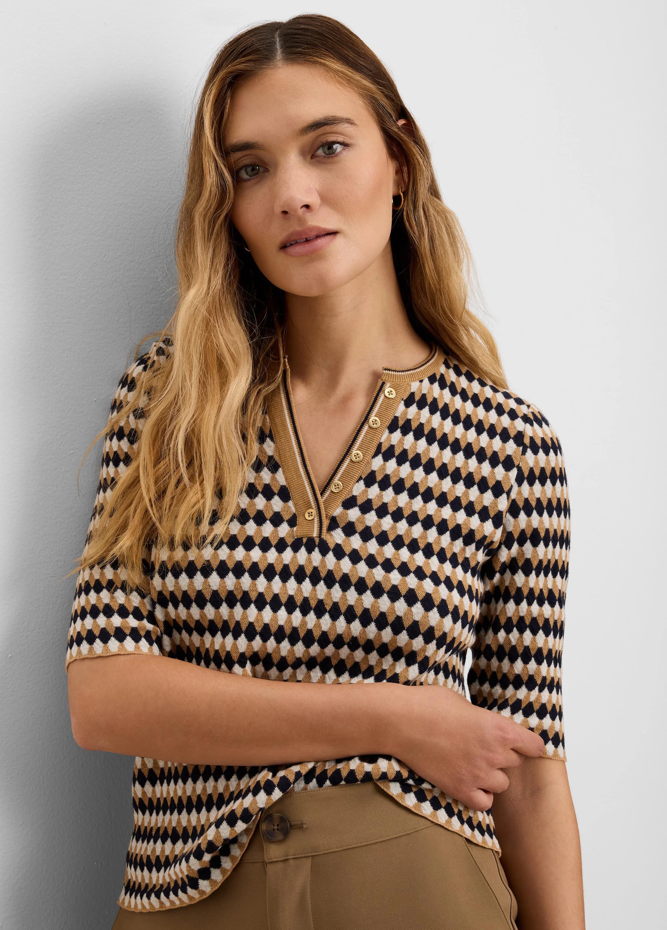 Navy, cream, & tan angled jacquard sweater with diamond pattern. Short-sleeved V-neck, button-front placket.