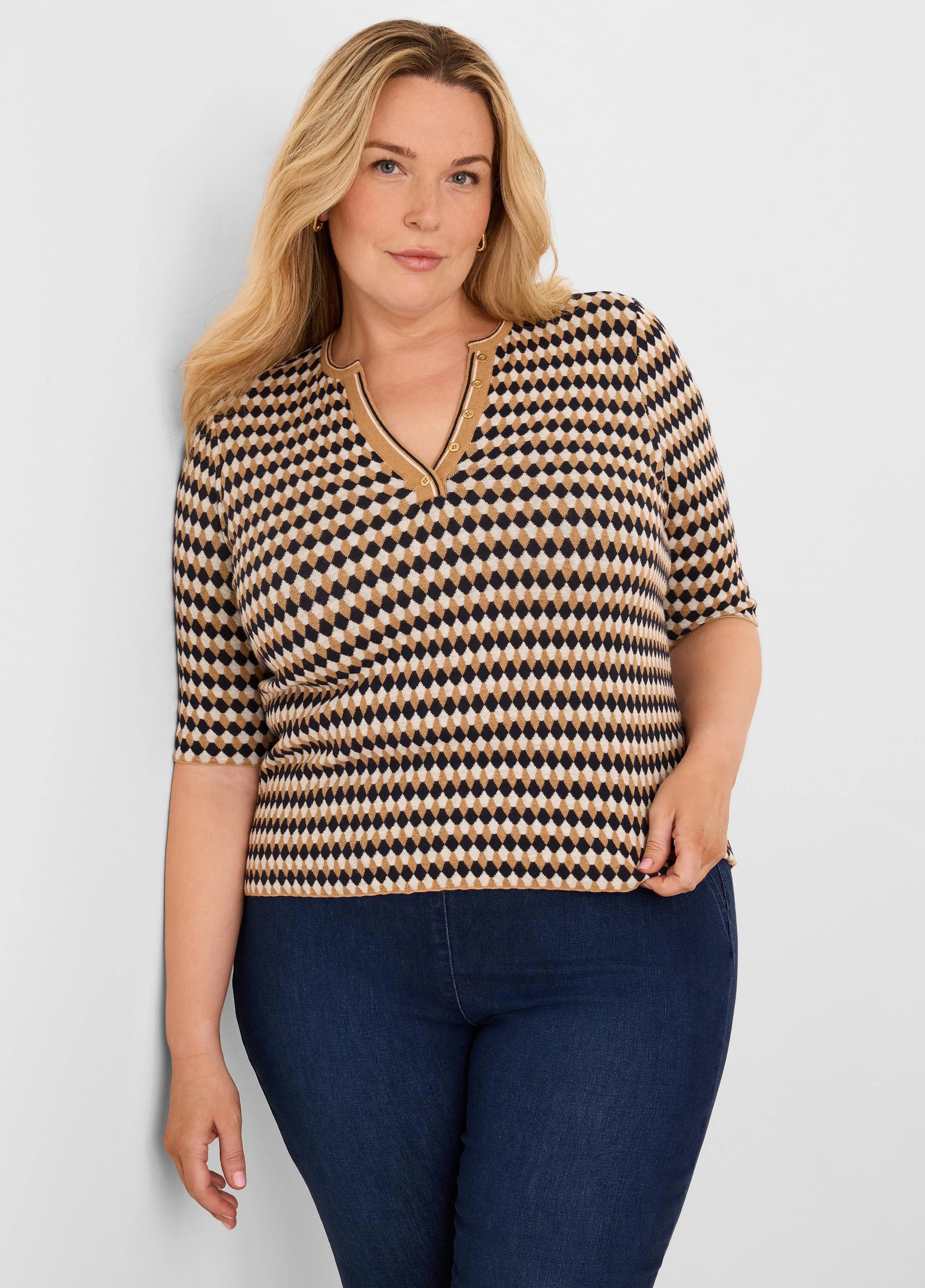 Angled jacquard sweater with black, tan, & beige diamond pattern. Features a V-neck with gold buttons & elbow-length sleeves.