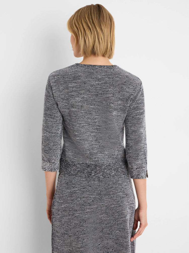 Tweed stitch sweater in speckled black, white, and blue with a round neck and 3/4 sleeves.