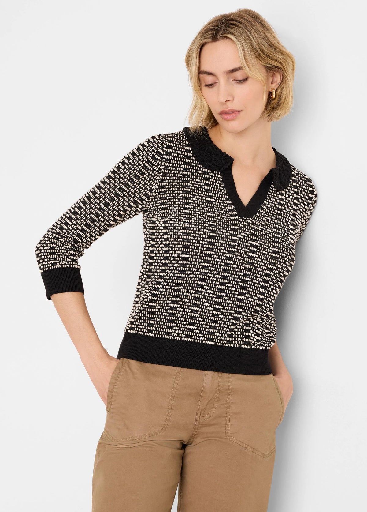 Black and off-white geo stitch sweater with a lace-trimmed V-neck collar, 3/4 sleeves, and ribbed cuffs/hem.