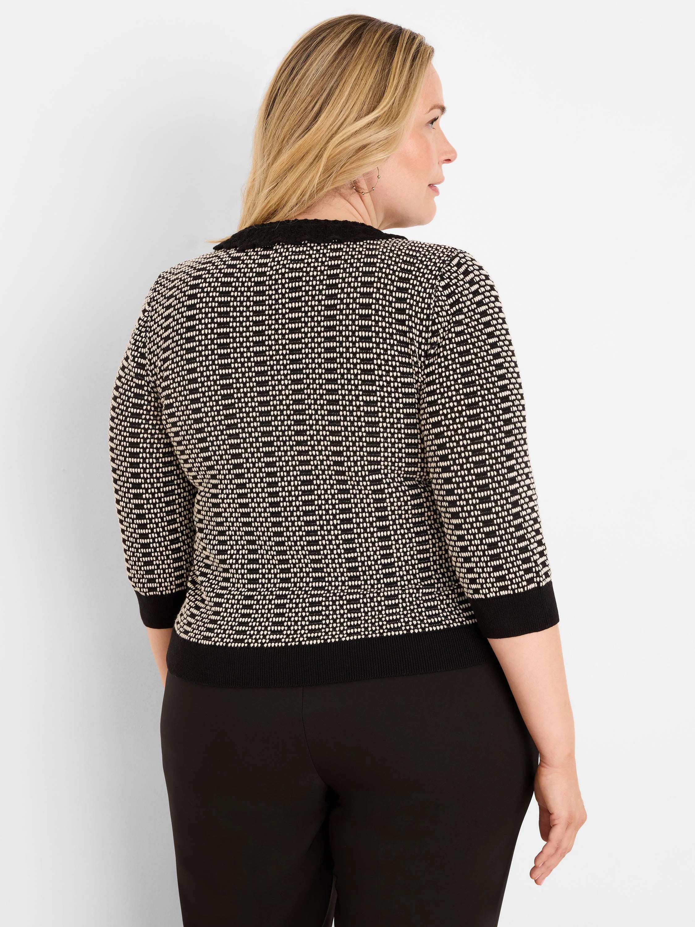 Black and cream geo stitch sweater with 3/4 sleeves and ribbed black trim on collar, cuffs, and hem.