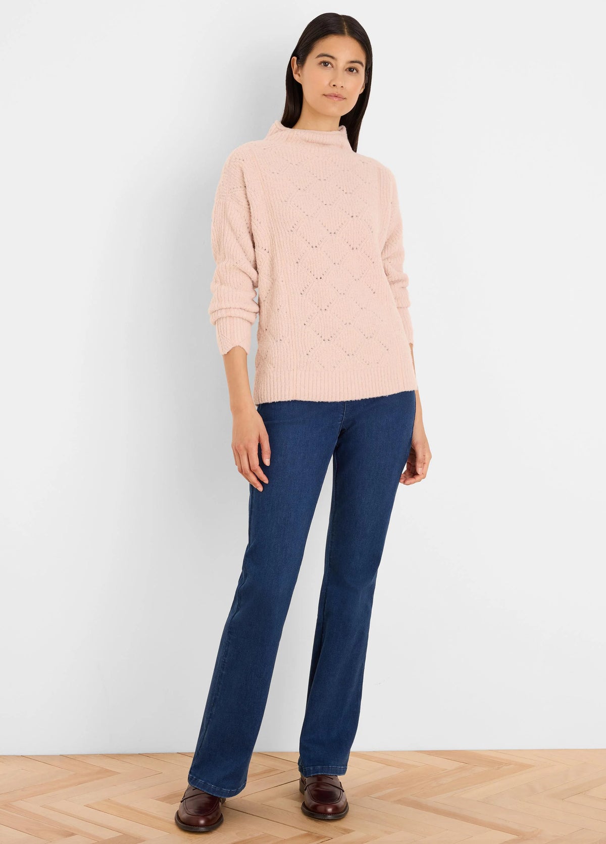 Pale pink, fuzzy mock neck sweater with a diamond knit pattern.