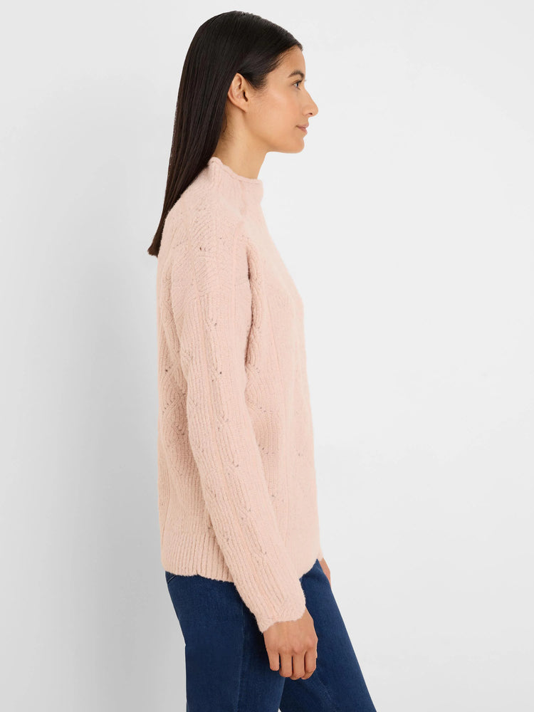 Light pink mock neck sweater with textured cable knit and speckled yarn.