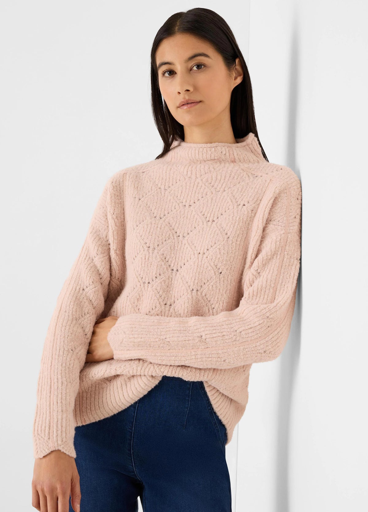 Light pink fuzzy mock neck sweater with diamond knit pattern and ribbed cuffs.