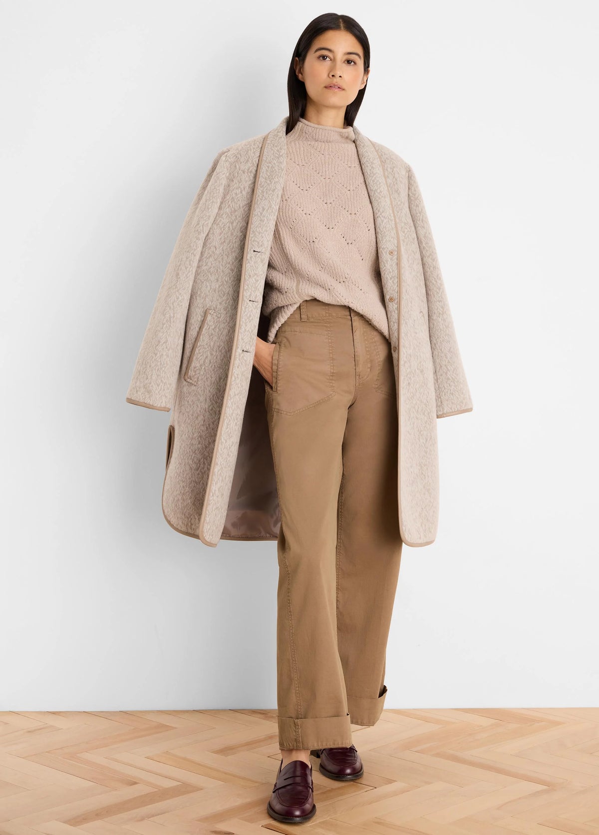 Light beige mock neck sweater with subtle diamond knit pattern.