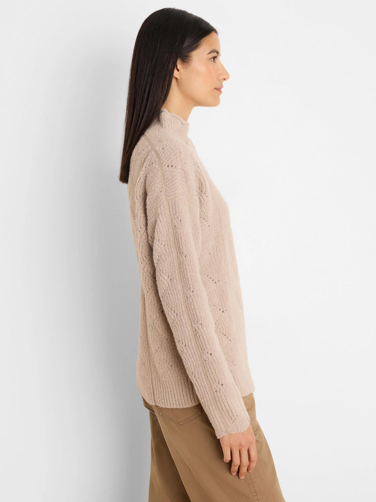 Fuzzy beige mock neck sweater with diamond cable knit pattern and ribbed cuffs & hem.