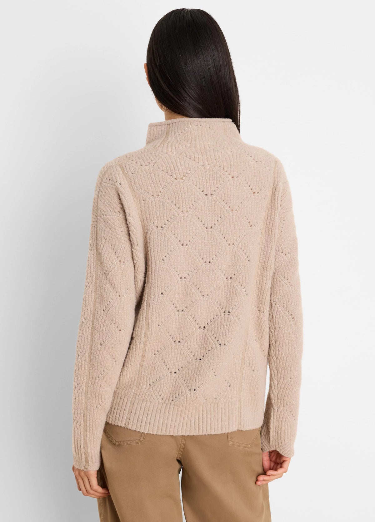 Beige high-neck sweater featuring an openwork diamond knit pattern, modeled from the back.