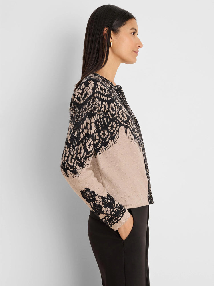 Cropped black and beige cardigan. Black lace print on shoulders, upper sleeves & cuffs. Beige body with subtle texture.