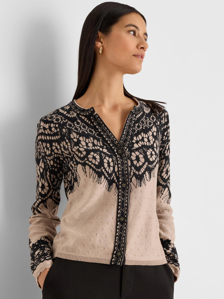 Beige cardigan with black lace print on the upper body and sleeves. V-neck, button-front.