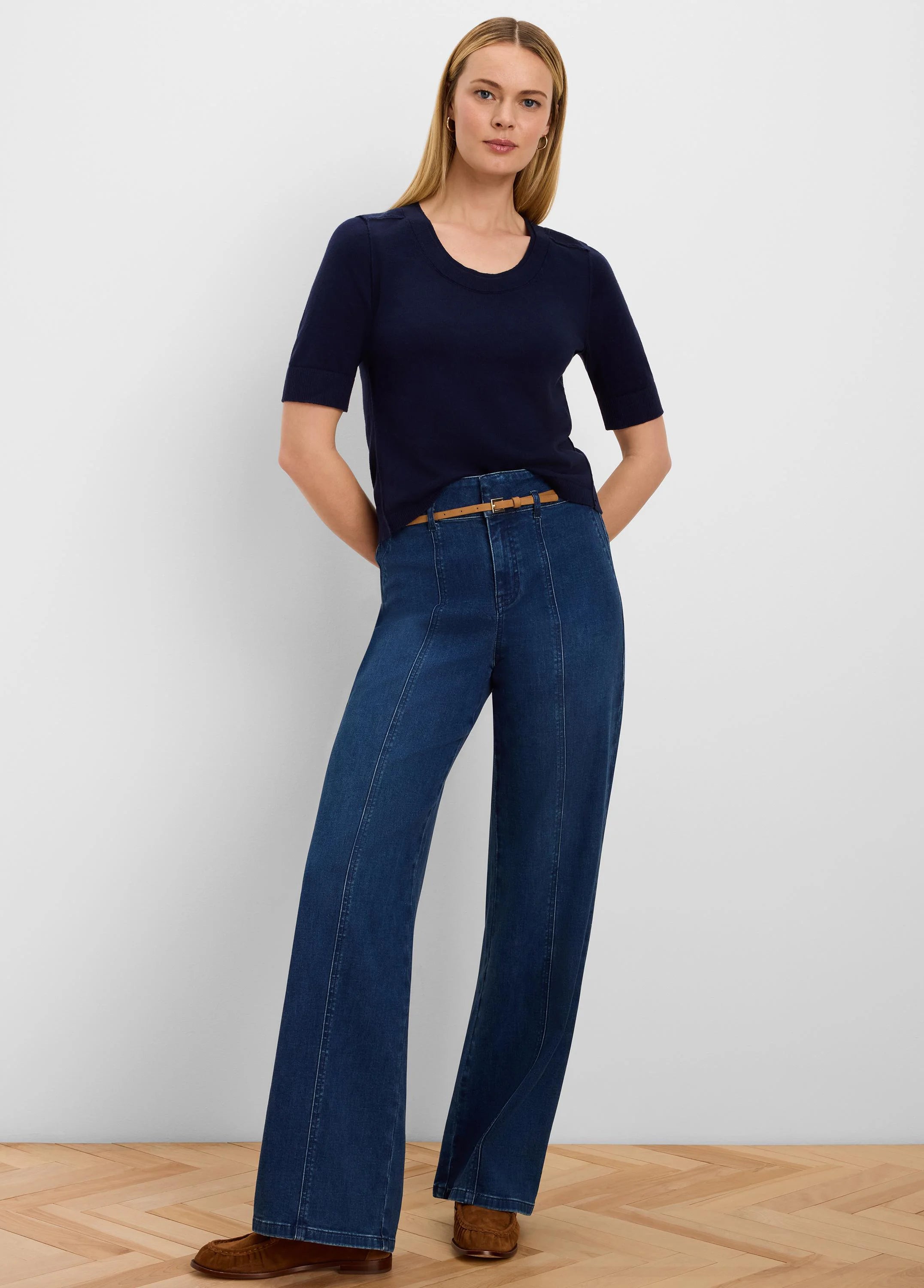 Navy pure cotton sweater tee with short sleeves, a round neck, and stitched shoulder details, worn by a woman.