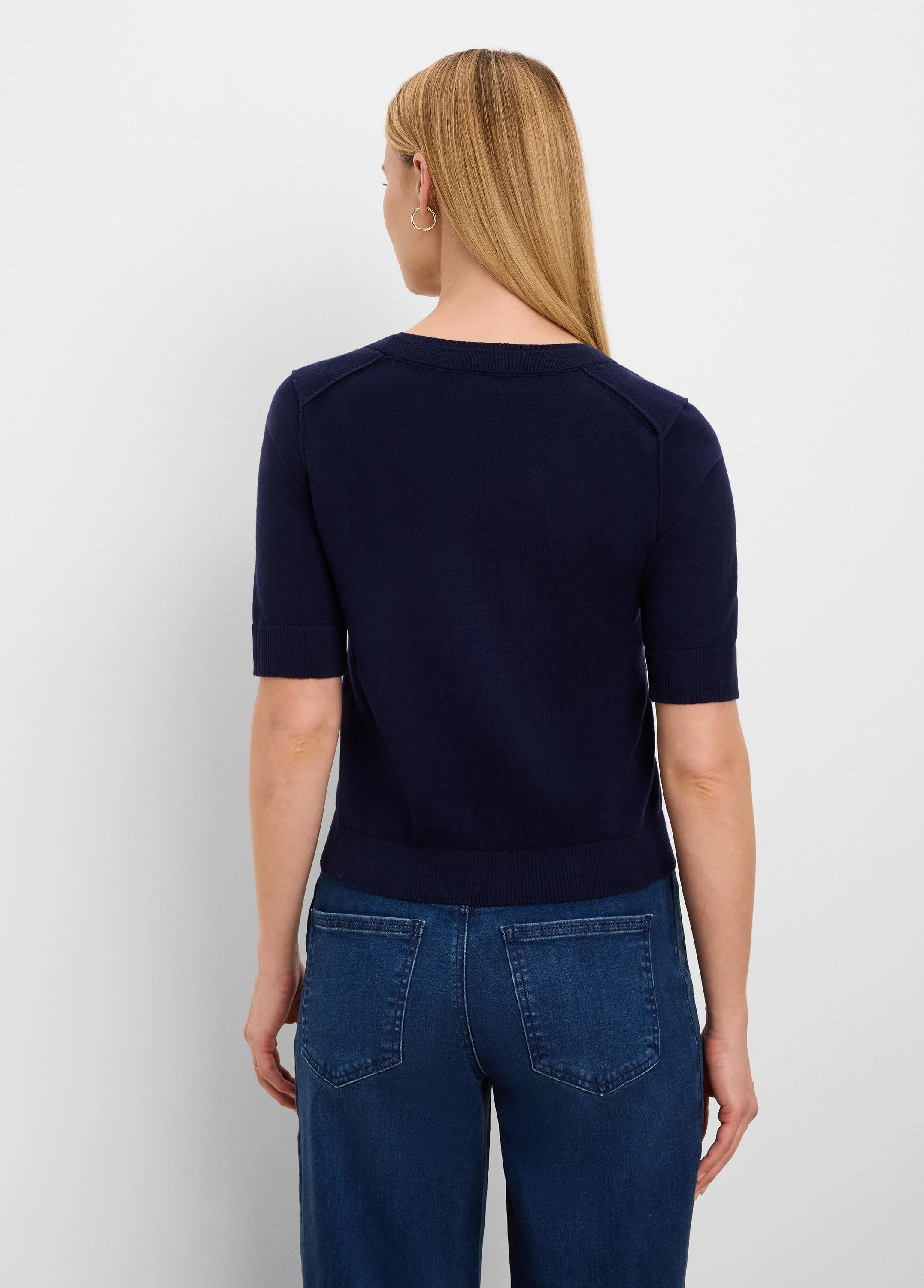 Navy short-sleeve sweater tee, back view. Features ribbed crew neck, sleeve cuffs, hem, and shoulder seam details.