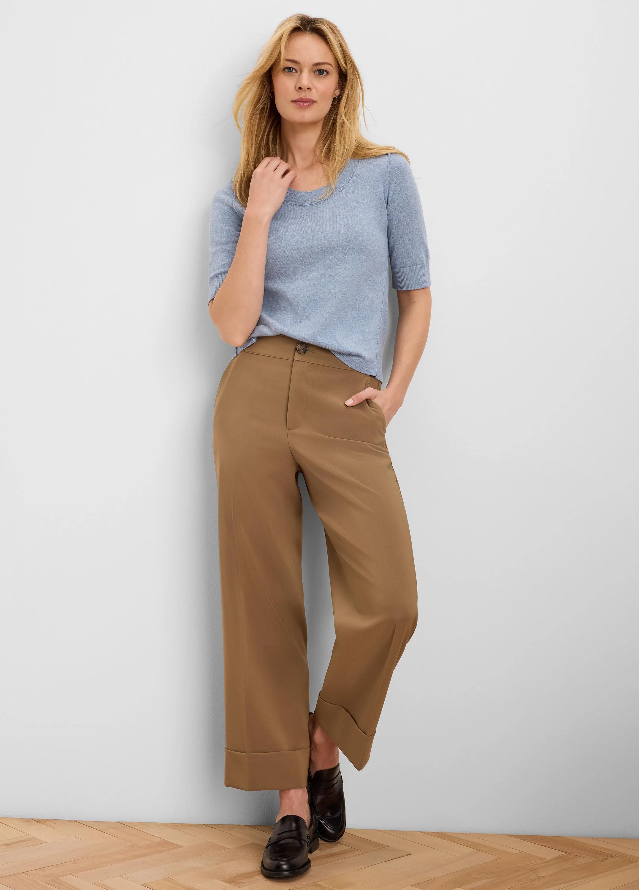 Pale blue, short-sleeved knit top with a rounded neckline.