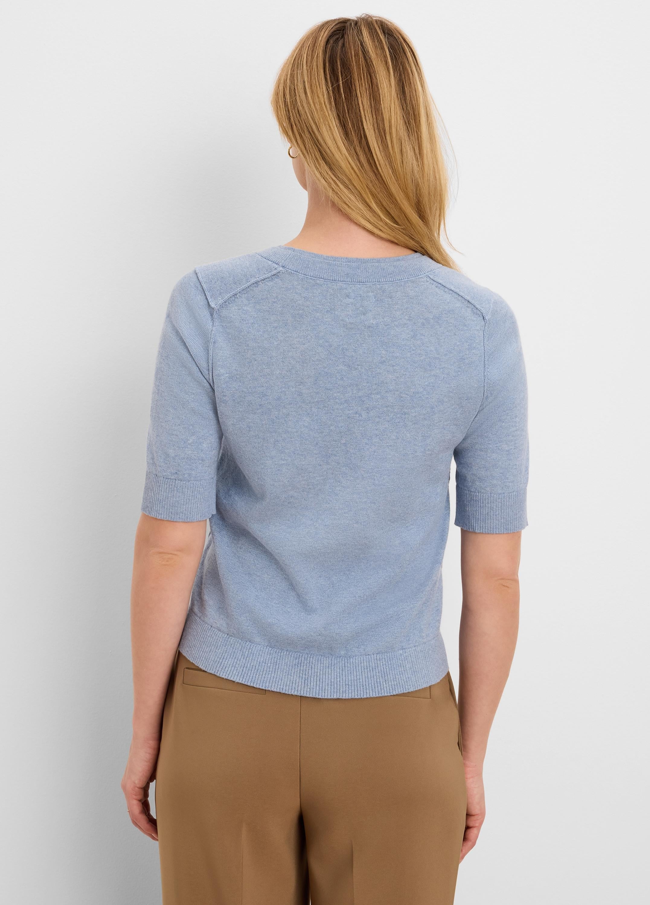 Light blue pure cotton sweater tee, back view. Short sleeves, ribbed round neck, cuffs, and bottom hem.