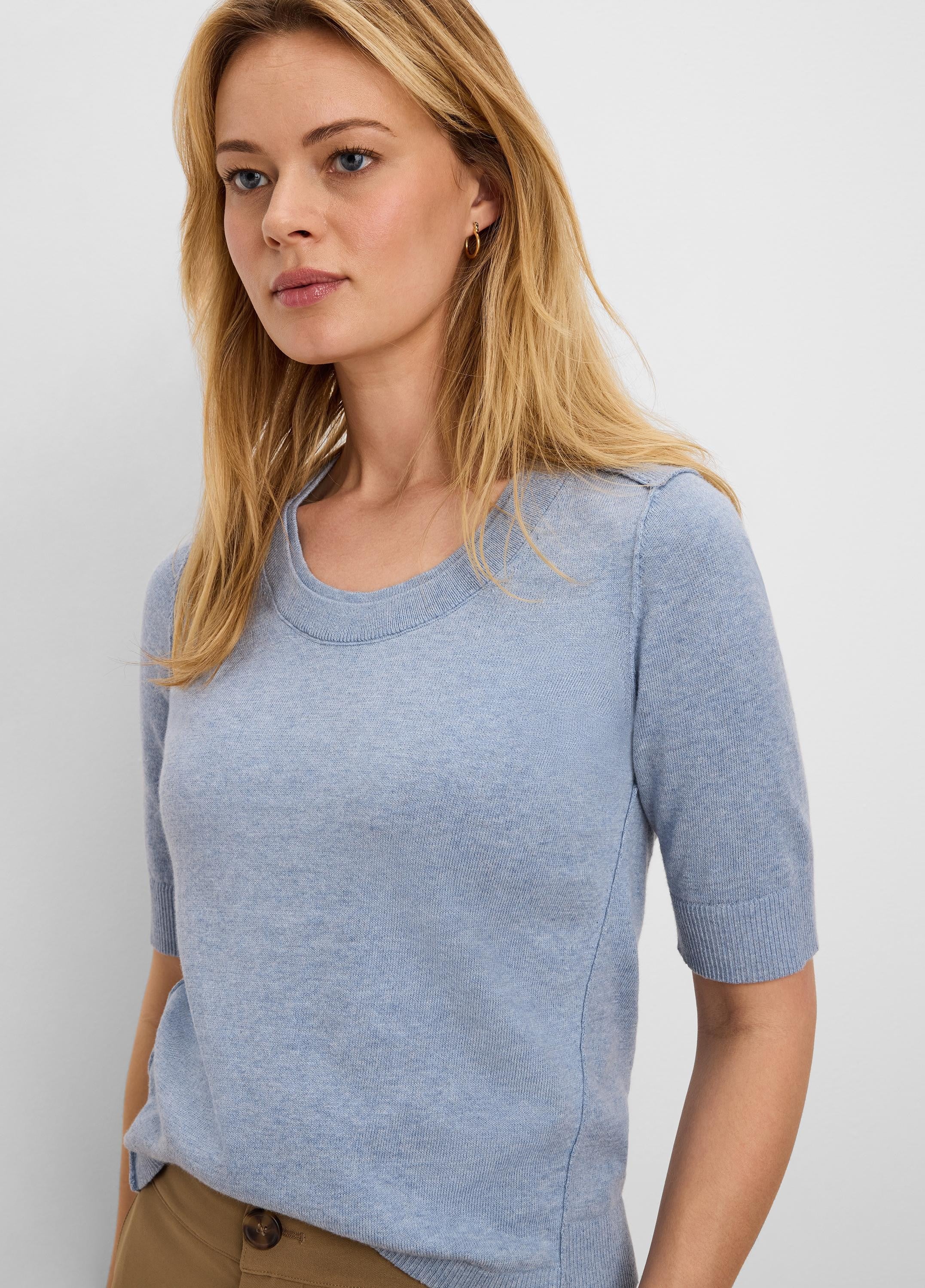 Light blue cotton sweater tee with short sleeves, crew neck, and fine knit texture.