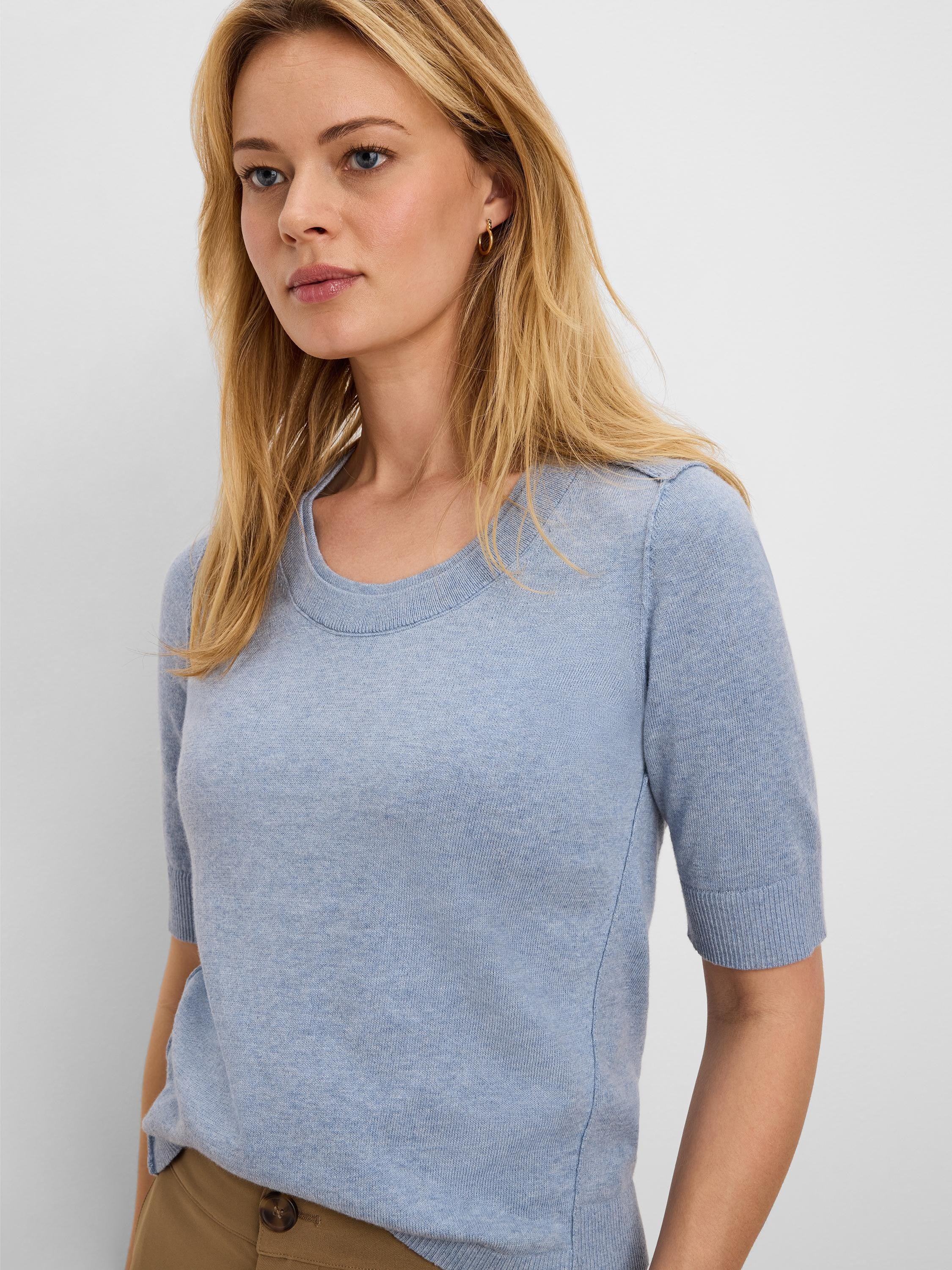 Light blue cotton sweater tee with short sleeves, crew neck, and fine knit texture.