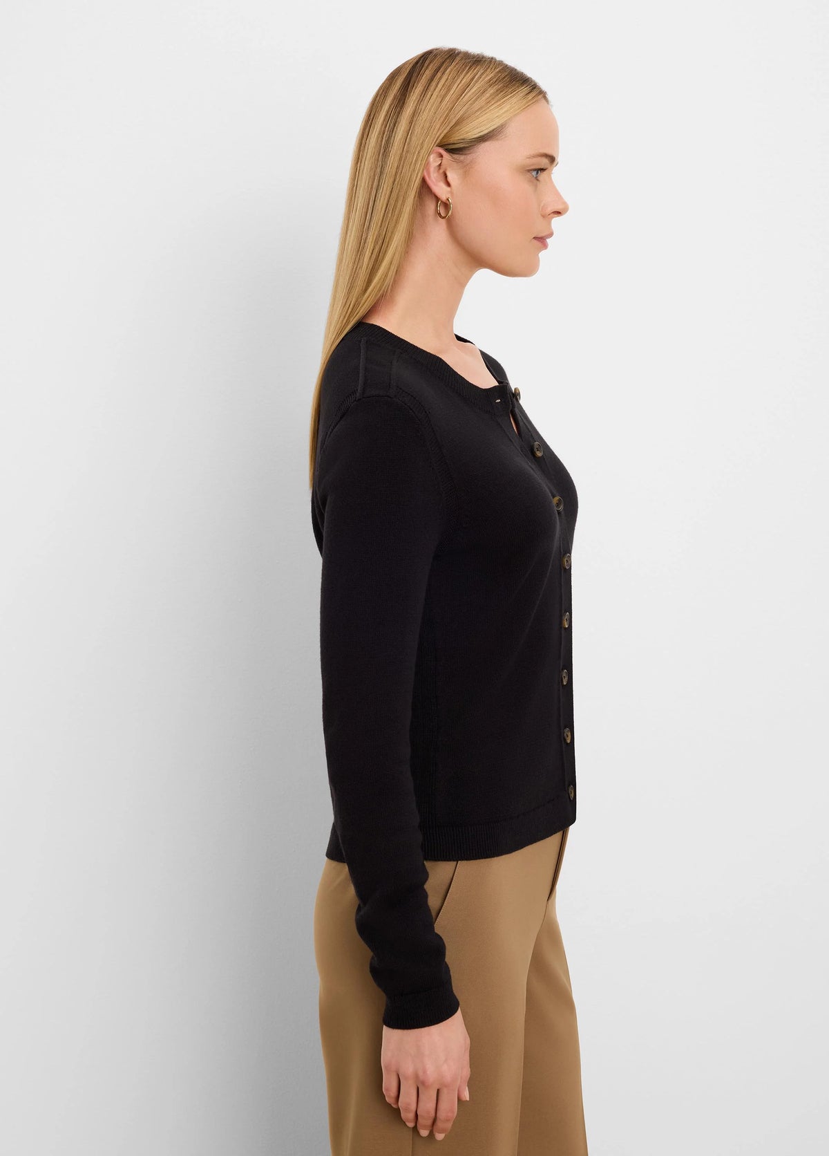 Black button-up cardigan with a round neck and long sleeves. Features contrasting light brown buttons.
