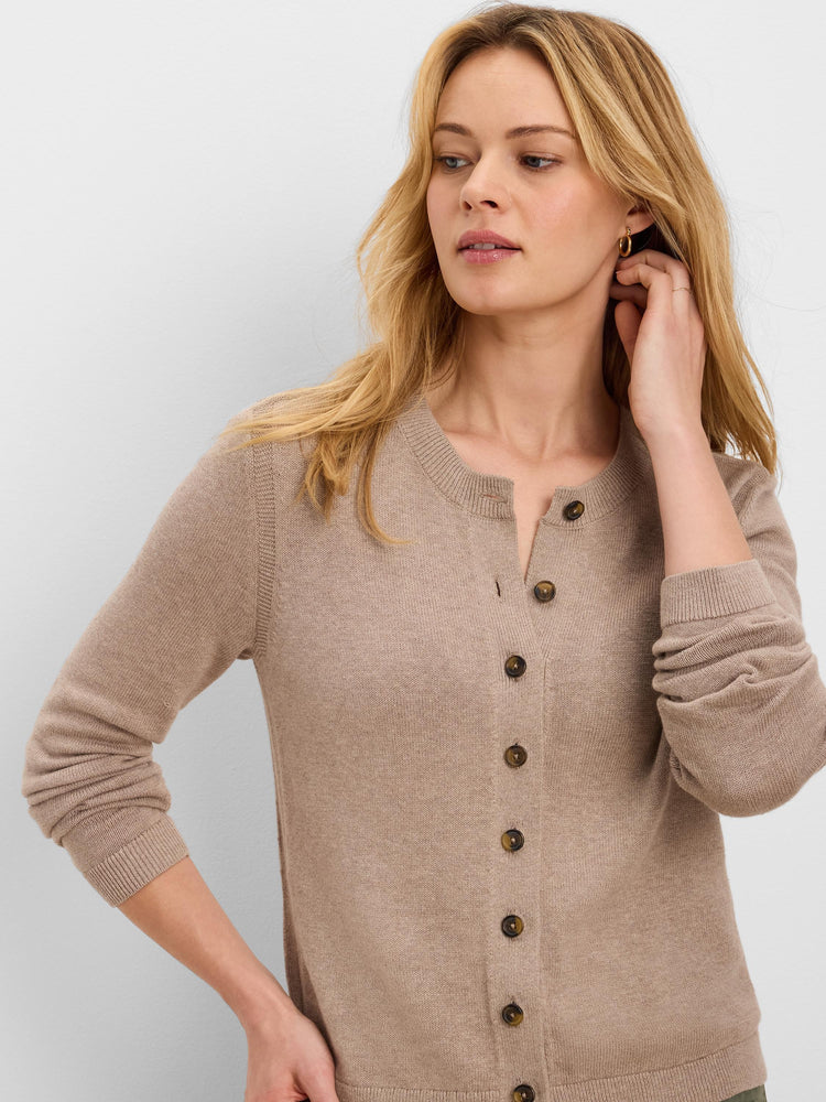 Light brown, round-neck cardigan featuring six visible dark brown speckled buttons. Worn by a woman.
