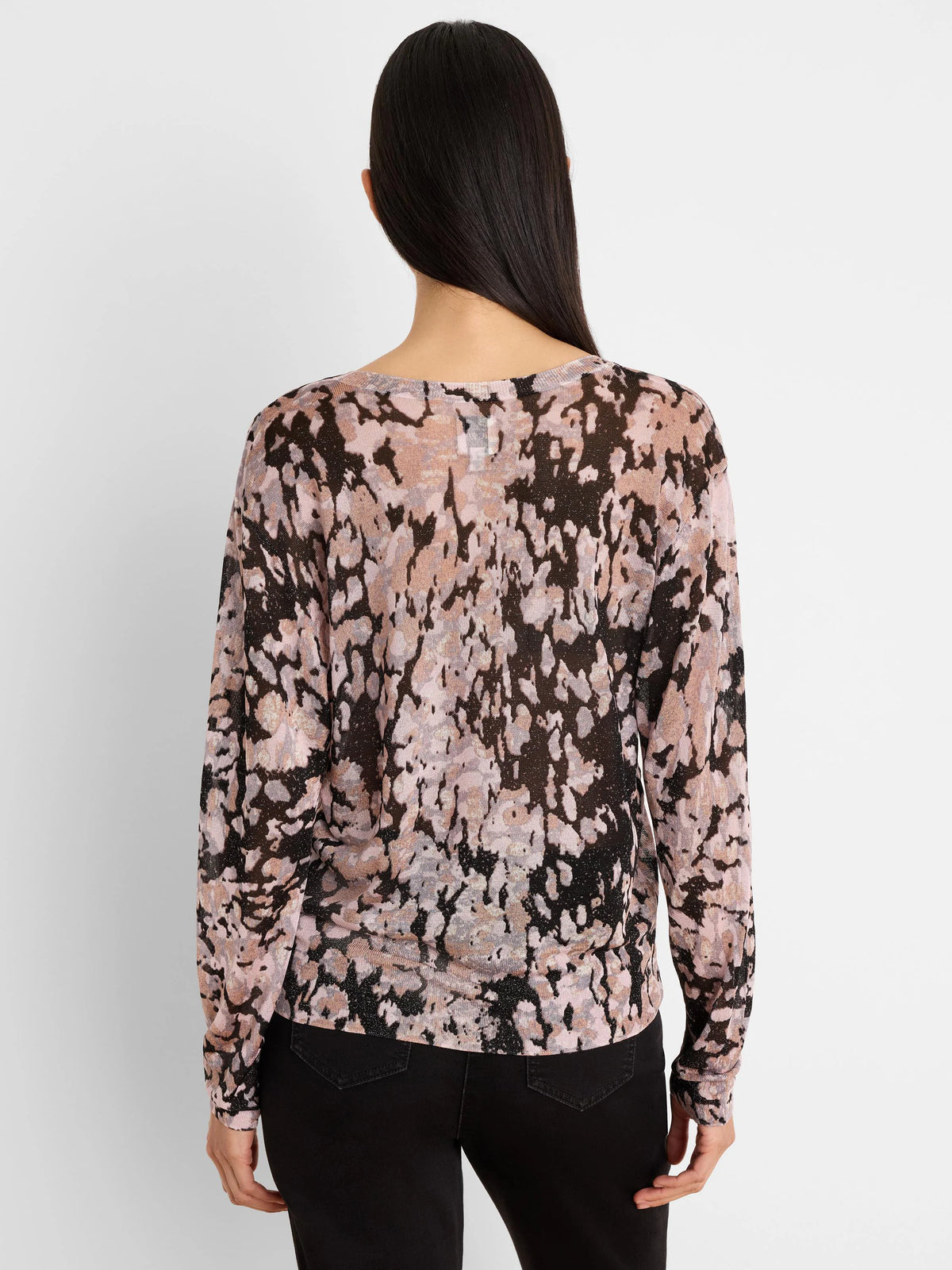 Back view of a long-sleeved sweater with an abstract pink, black, and beige mottled pattern, featuring subtle shimmer.