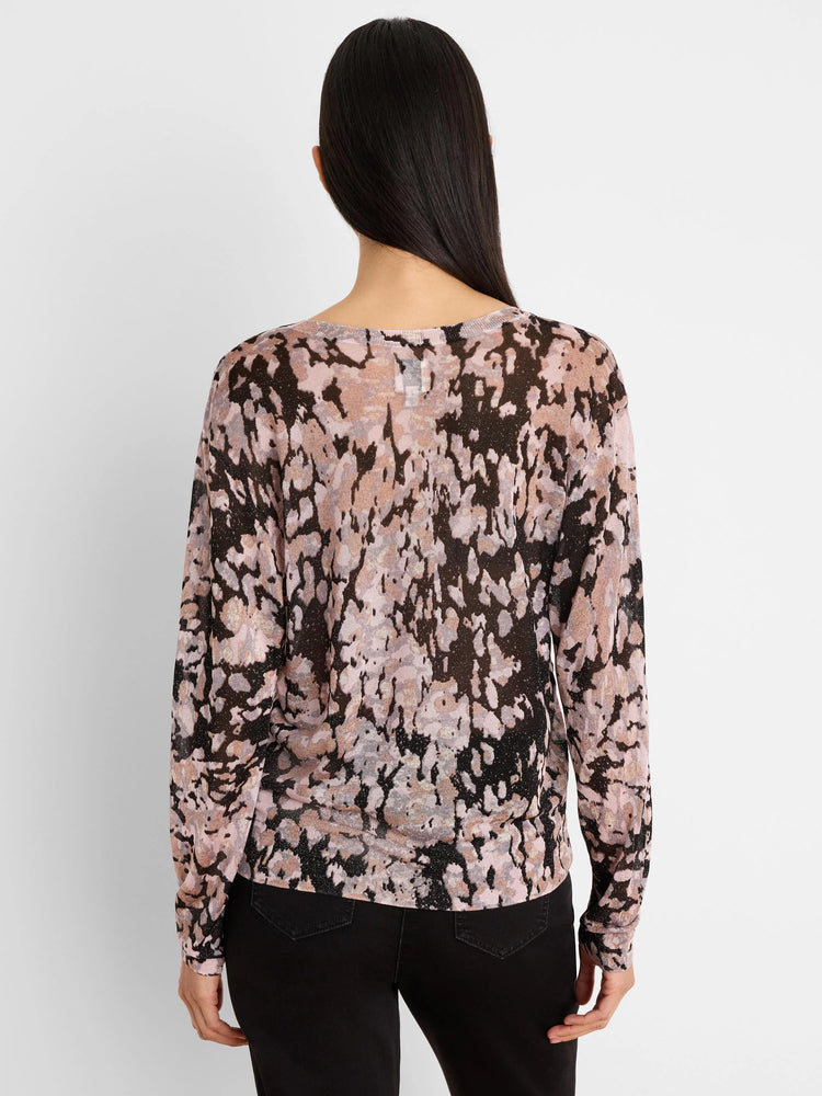 Back view of a long-sleeved sweater with an abstract pink, black, and beige mottled pattern, featuring subtle shimmer.