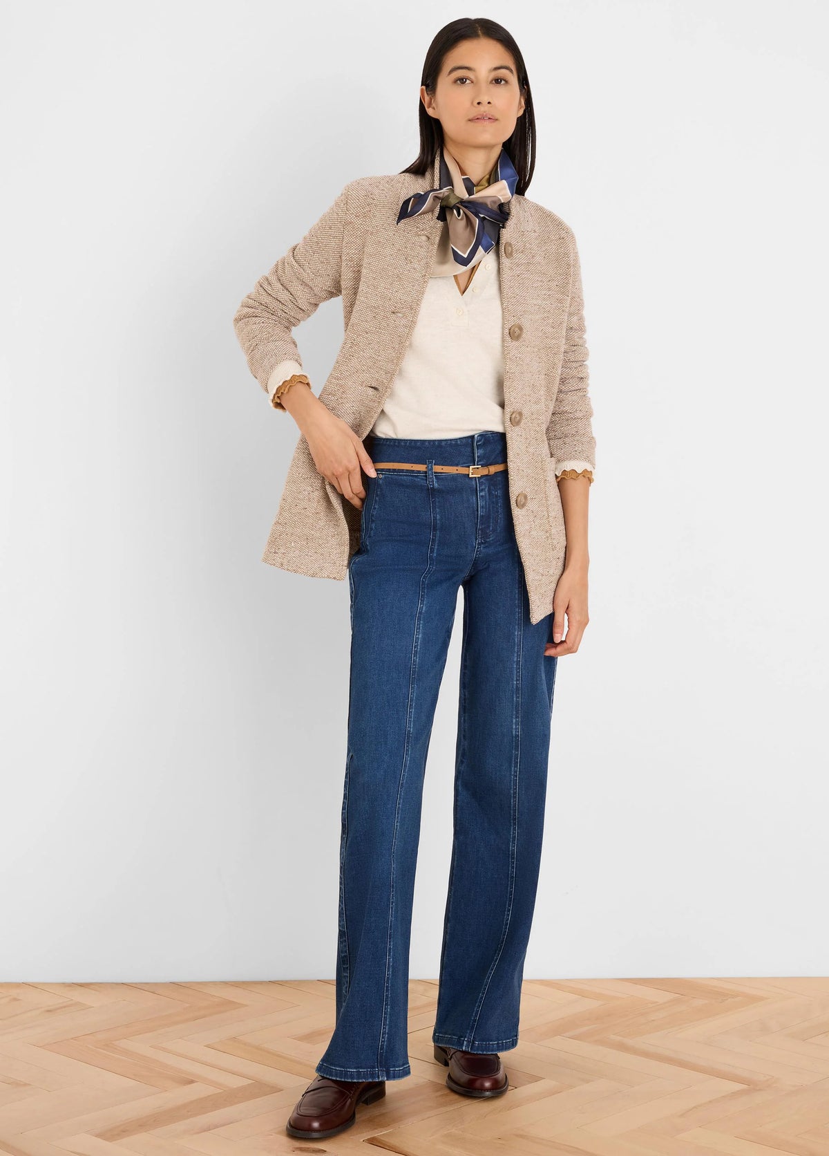 Speckled beige tweed stitch sweater jacket, collarless with buttoned front.
