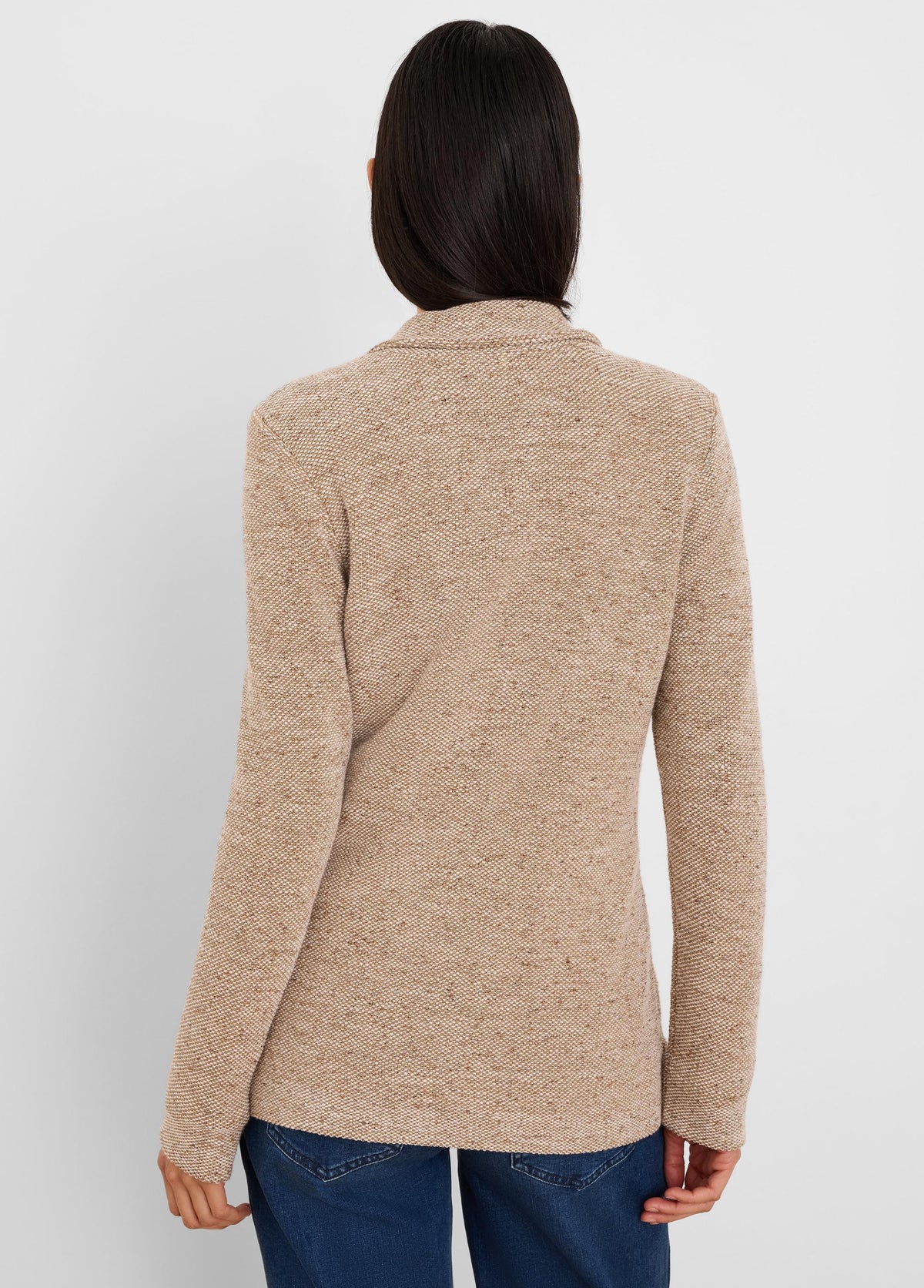 Back of a light brown tweed stitch sweater jacket with dark flecks and a textured knit.
