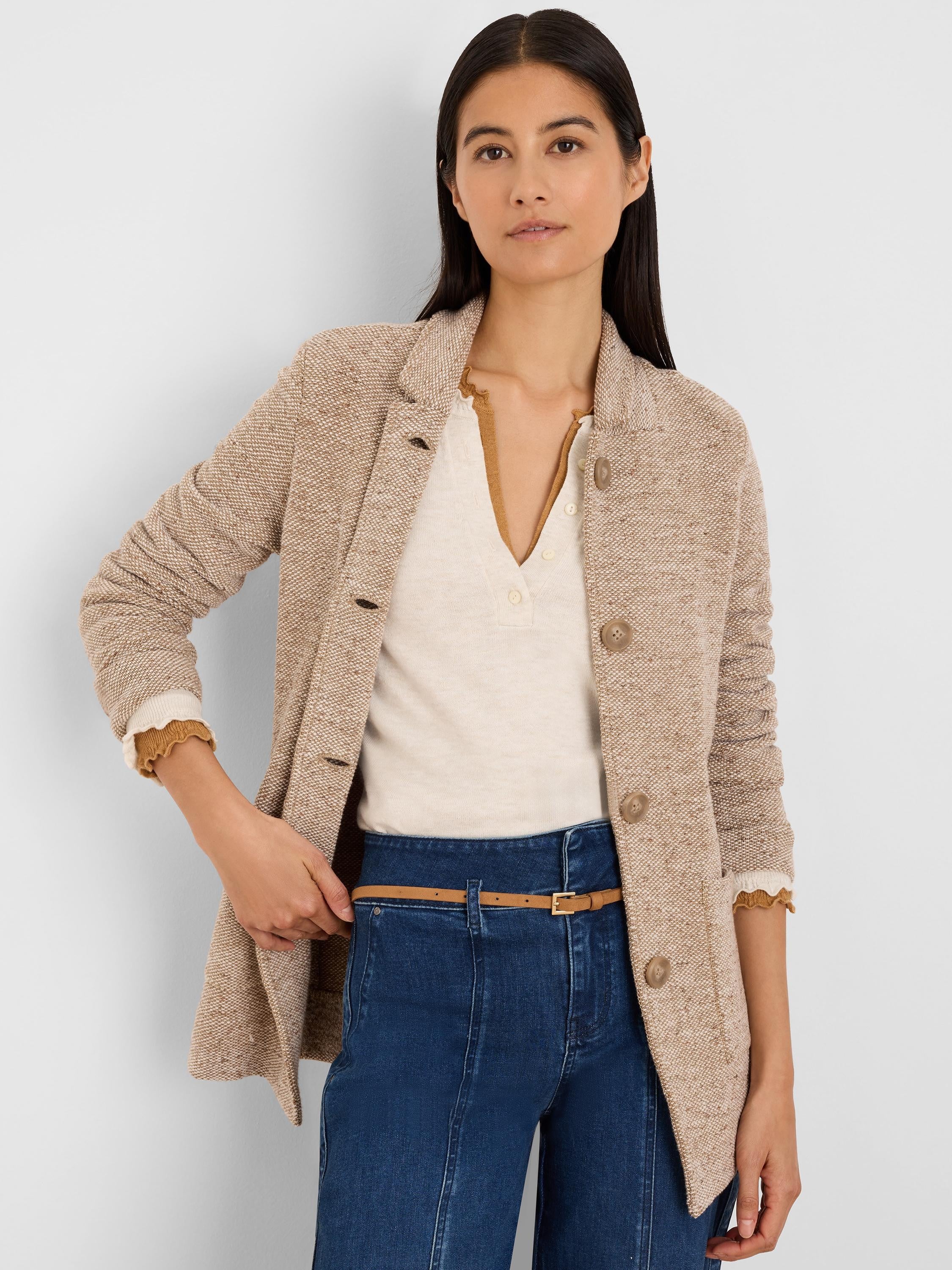 Light beige tweed stitch sweater jacket, collared with three front buttons.