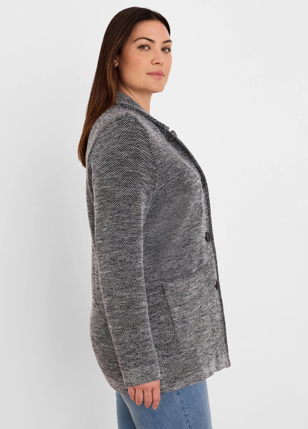 Black and white tweed stitch sweater jacket, open front, with two dark buttons and front patch pockets.