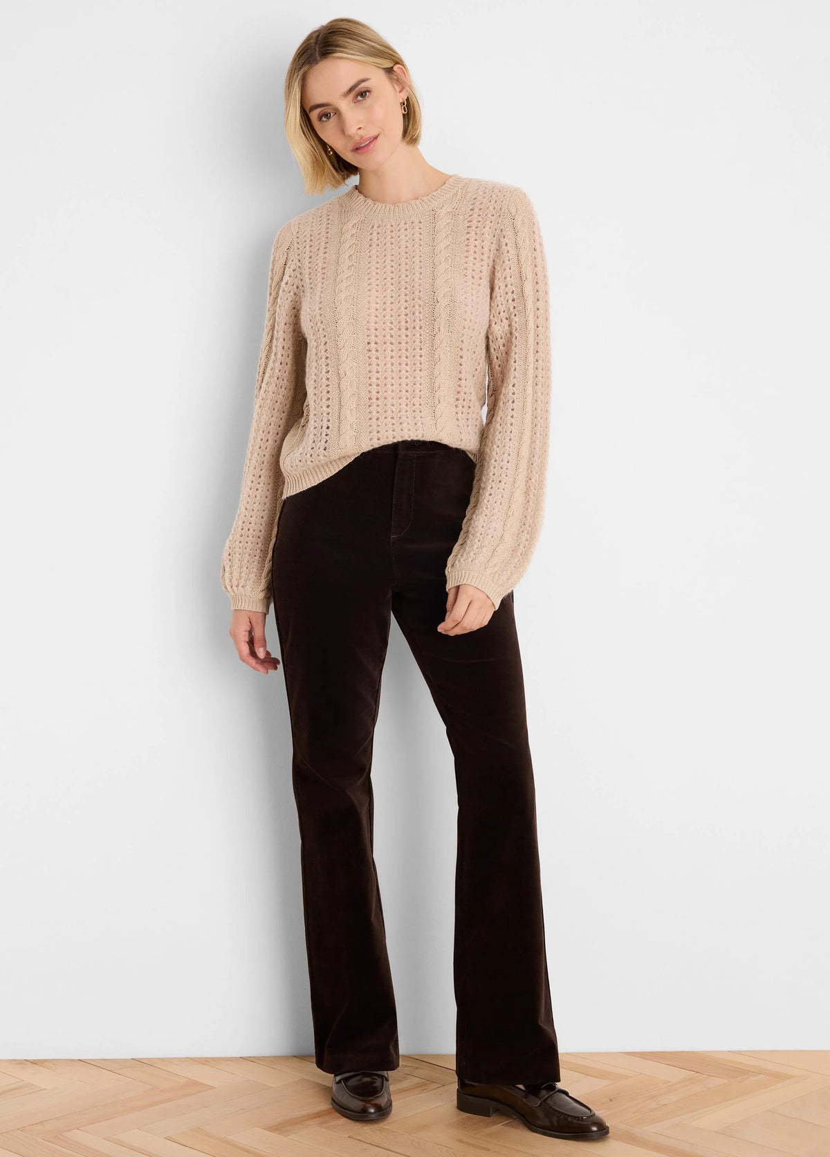 Light beige knit sweater with mixed cable and openwork patterns.