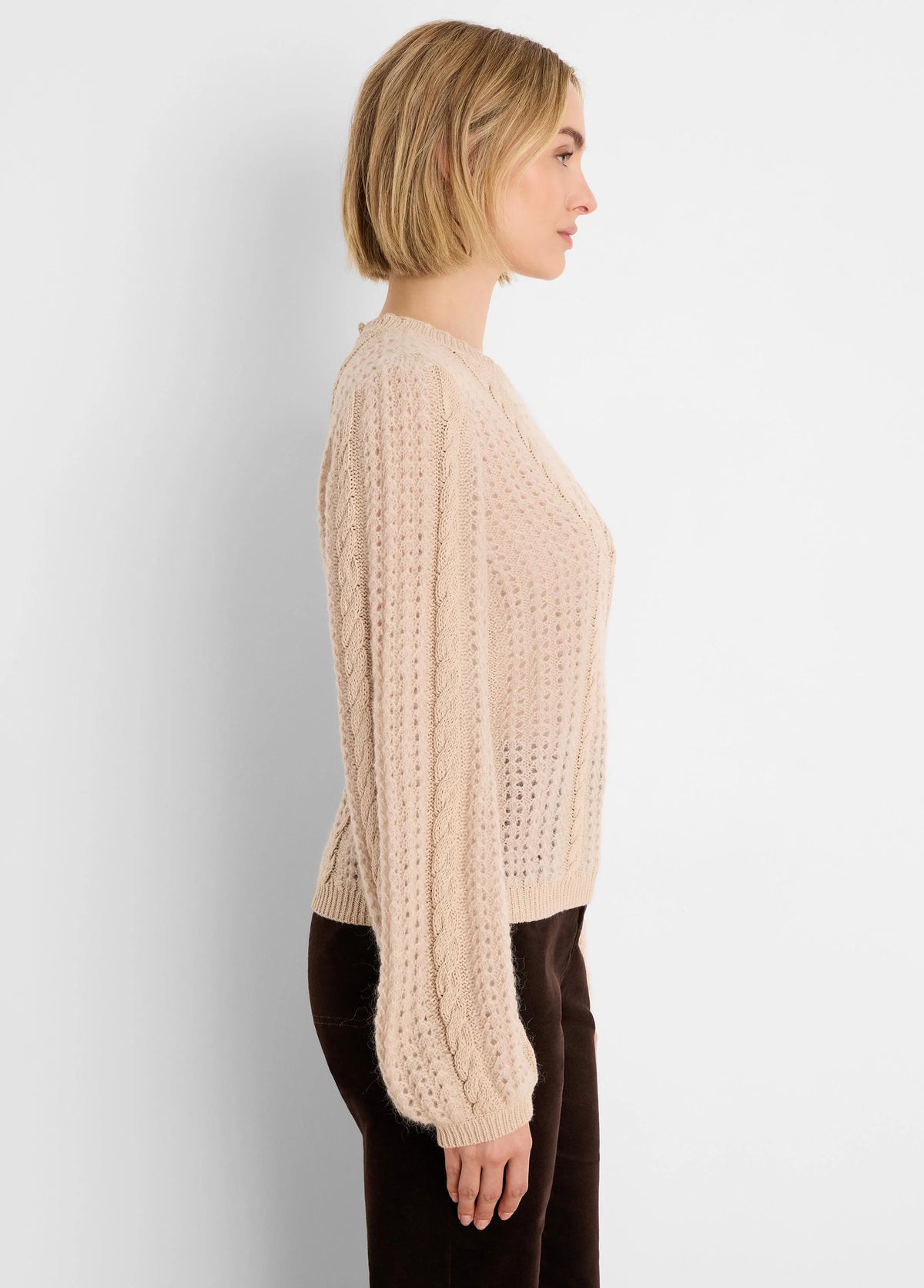 Light beige sweater with voluminous cable knit sleeves and an openwork body.