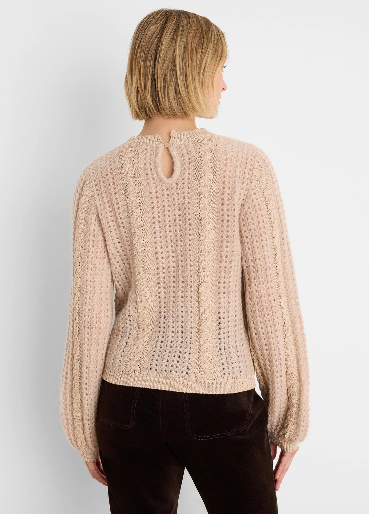 Light beige sweater, mixed cable and open-stitch knit, keyhole button at back neck.