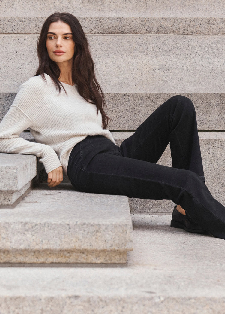 Cream ribbed long-sleeve sweater, relaxed fit, and crew neck.