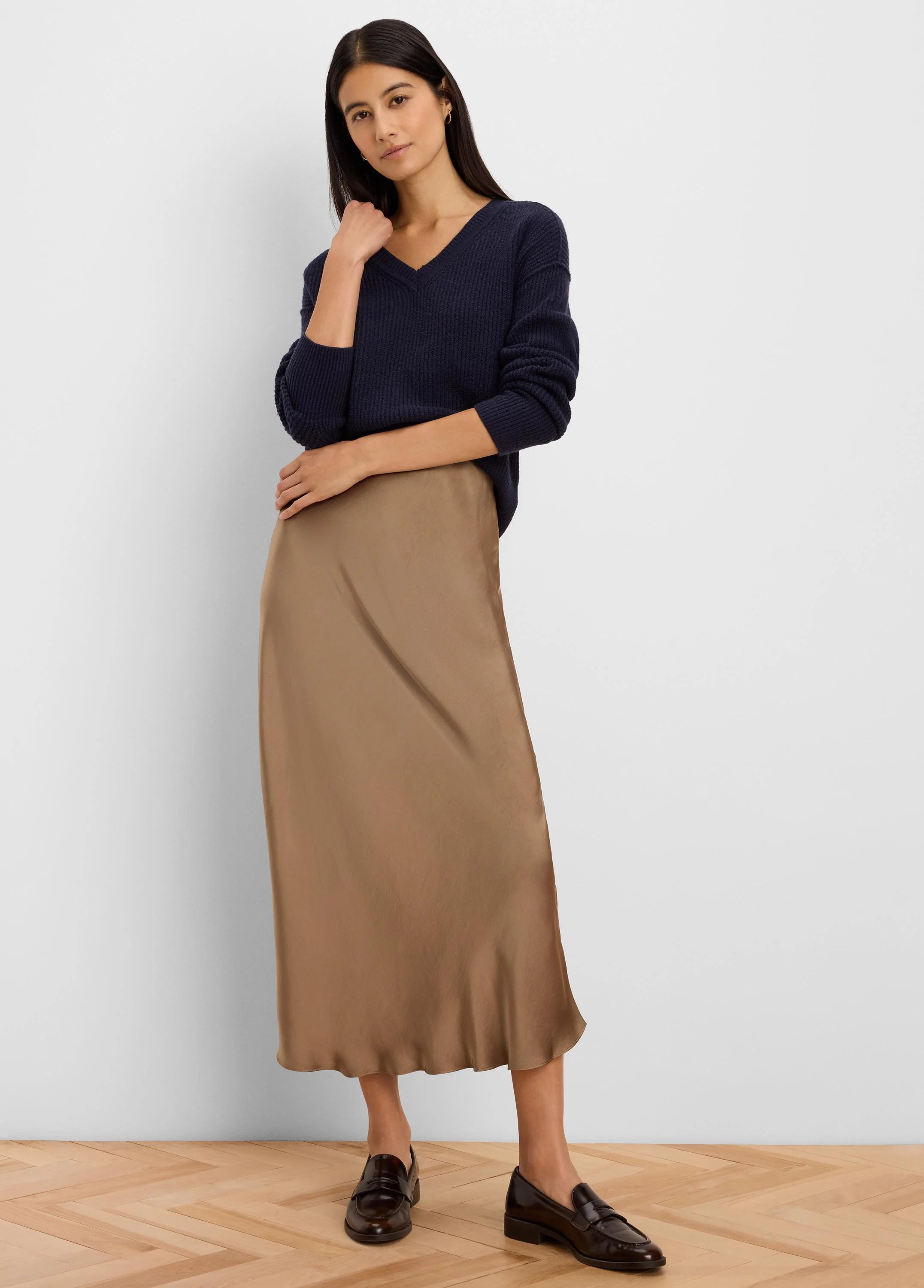 Navy blue V-neck ribbed knit sweater on a model.