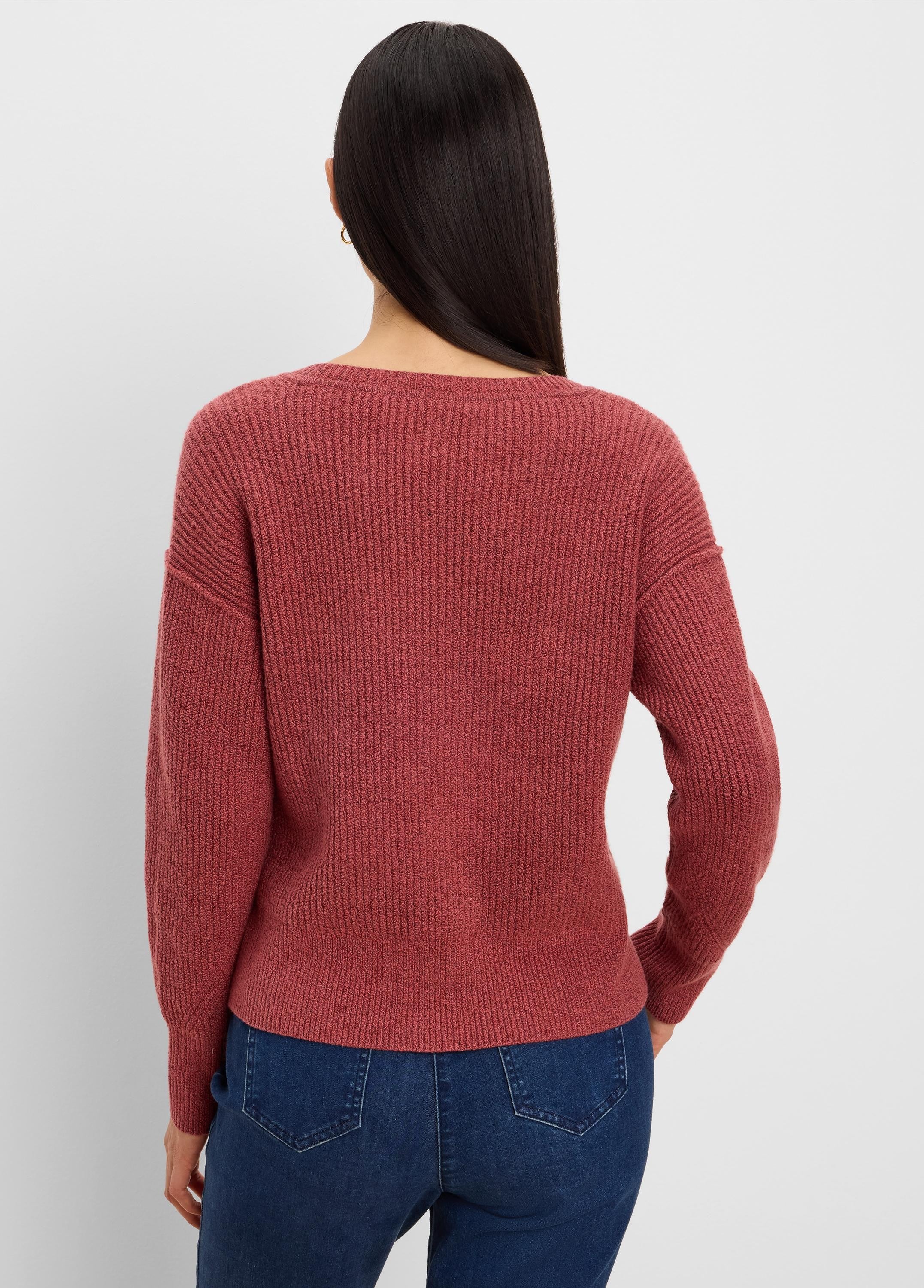 Rust ribbed knit sweater seen from the back on a model wearing jeans. Features a wide scoop neckline.
