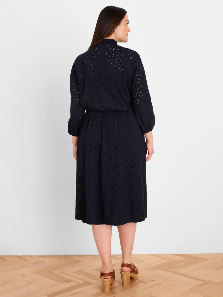 Dark blue eyelet dress, midi length, with a ruffled high neckline and elasticated waist.