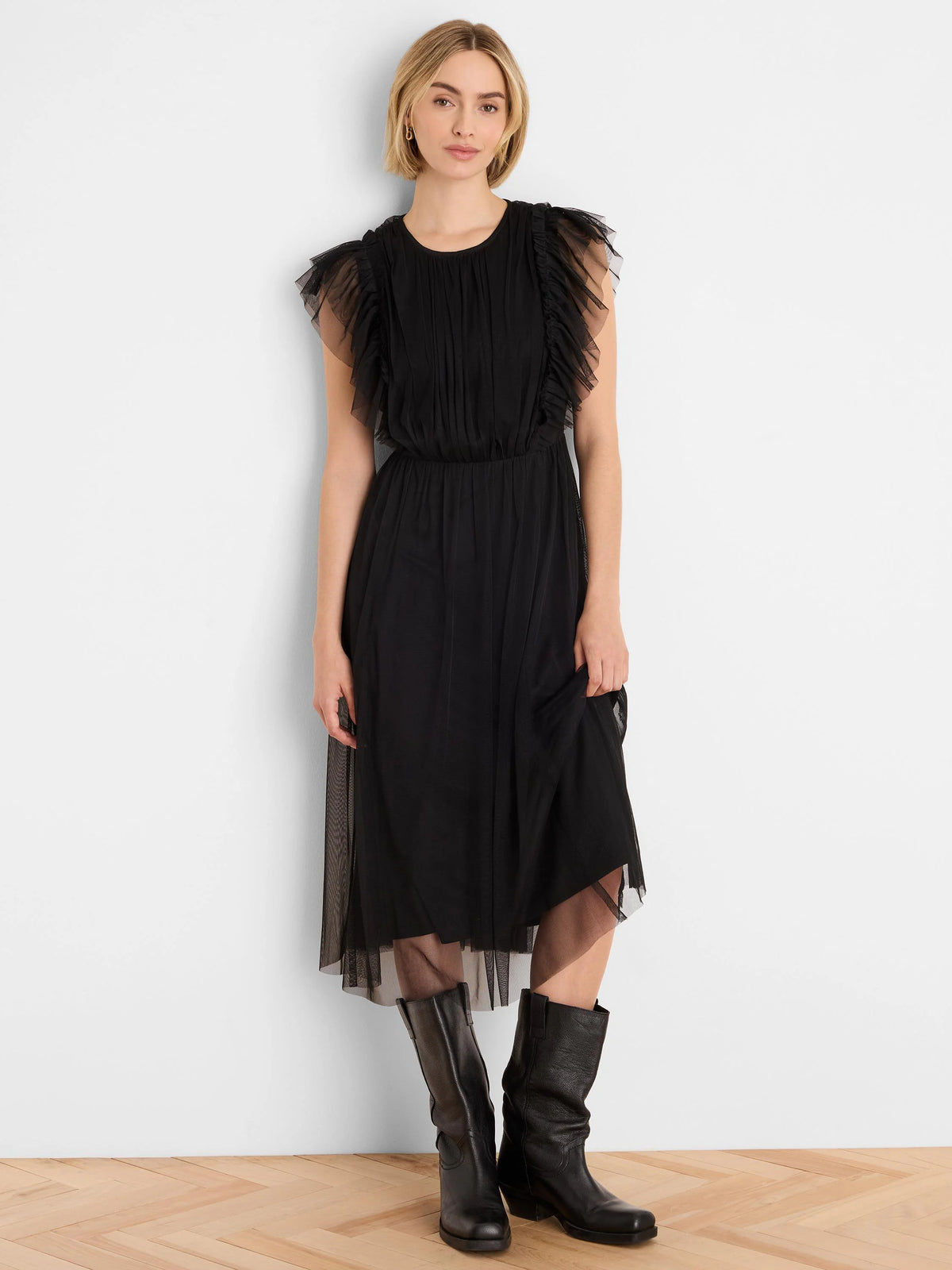 Round neck black tulle midi dress with pleated bodice, ruffled shoulders, and a sheer layered skirt.
