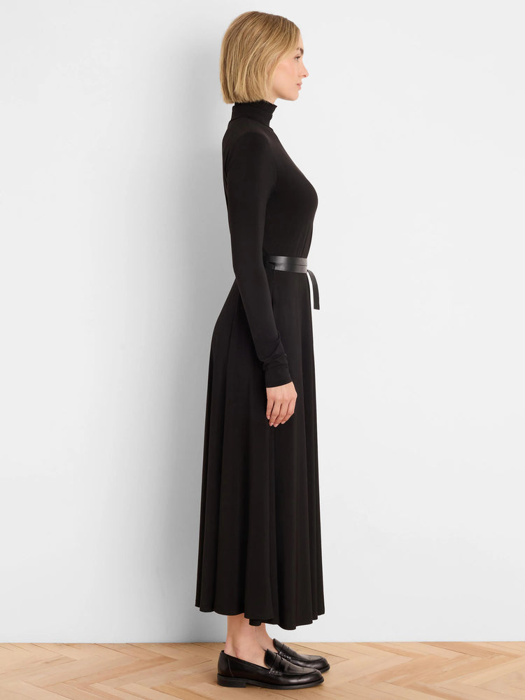 Black high neck, long-sleeve maxi dress with a cinched waist and thin black belt.