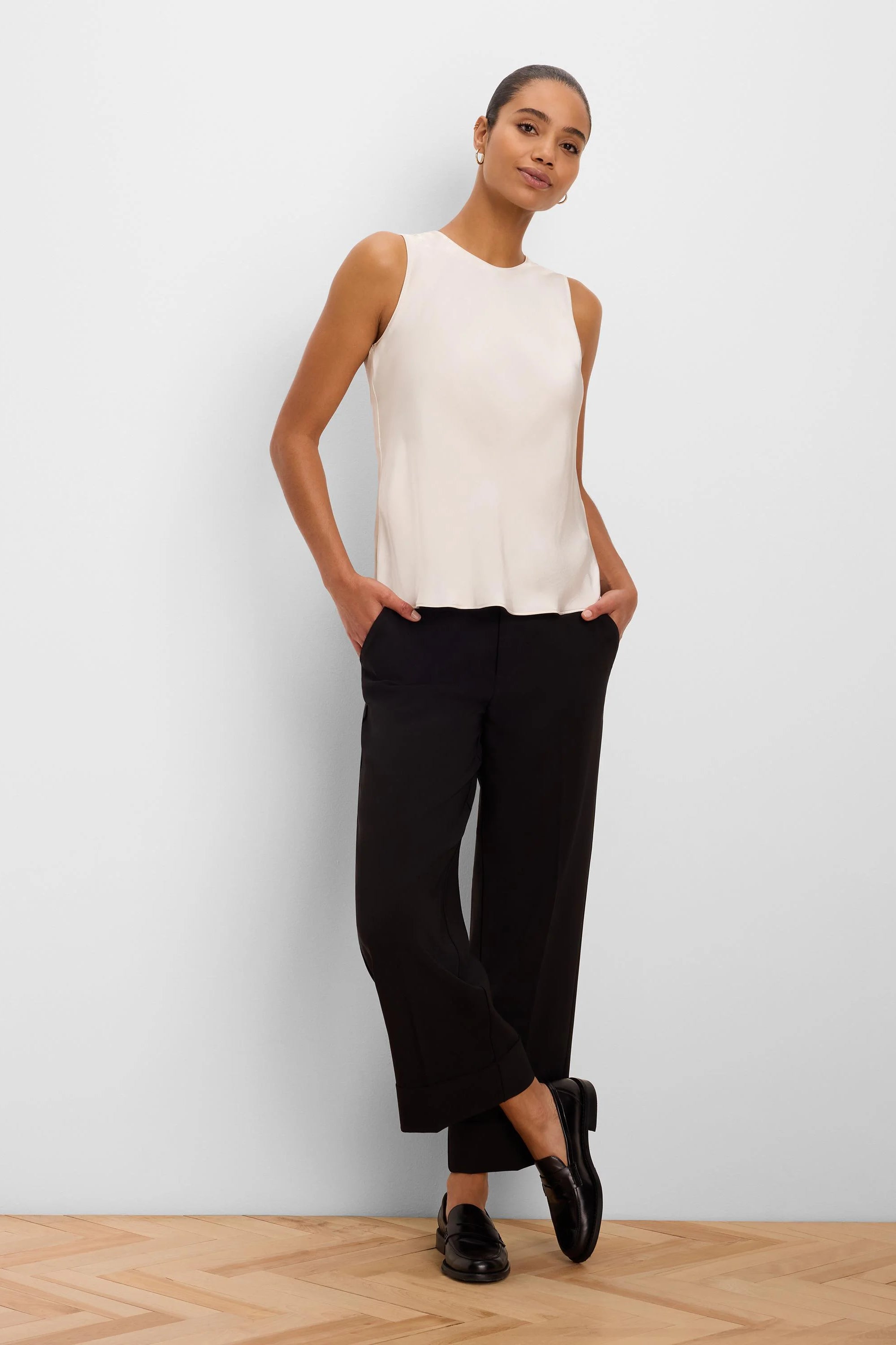 Black cuffed ankle pants with a straight-leg fit.