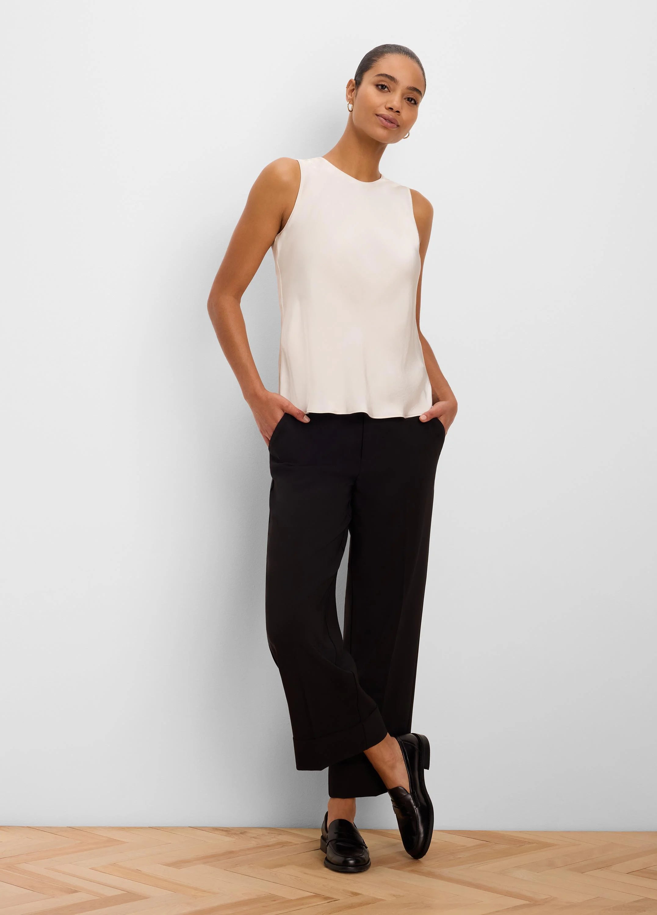 Black cuffed ankle pants with a straight-leg fit.