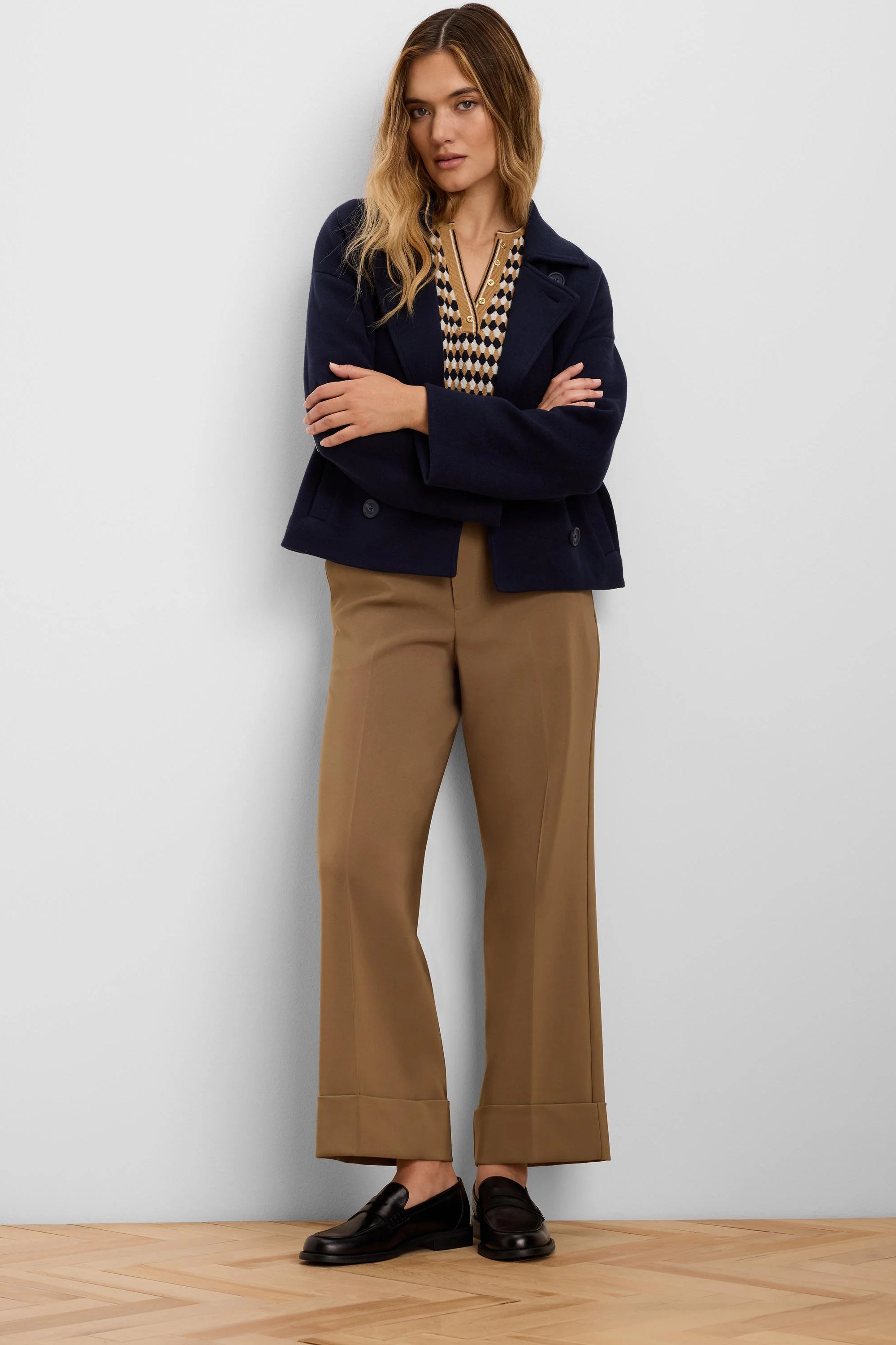 Camel brown wide-leg pants with deep cuffed ankles.