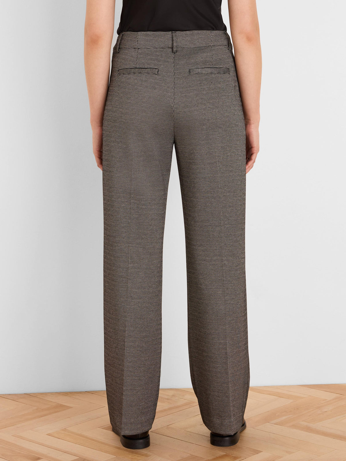 Brown and beige houndstooth tweed wide leg trousers, back view, with back welt pockets.