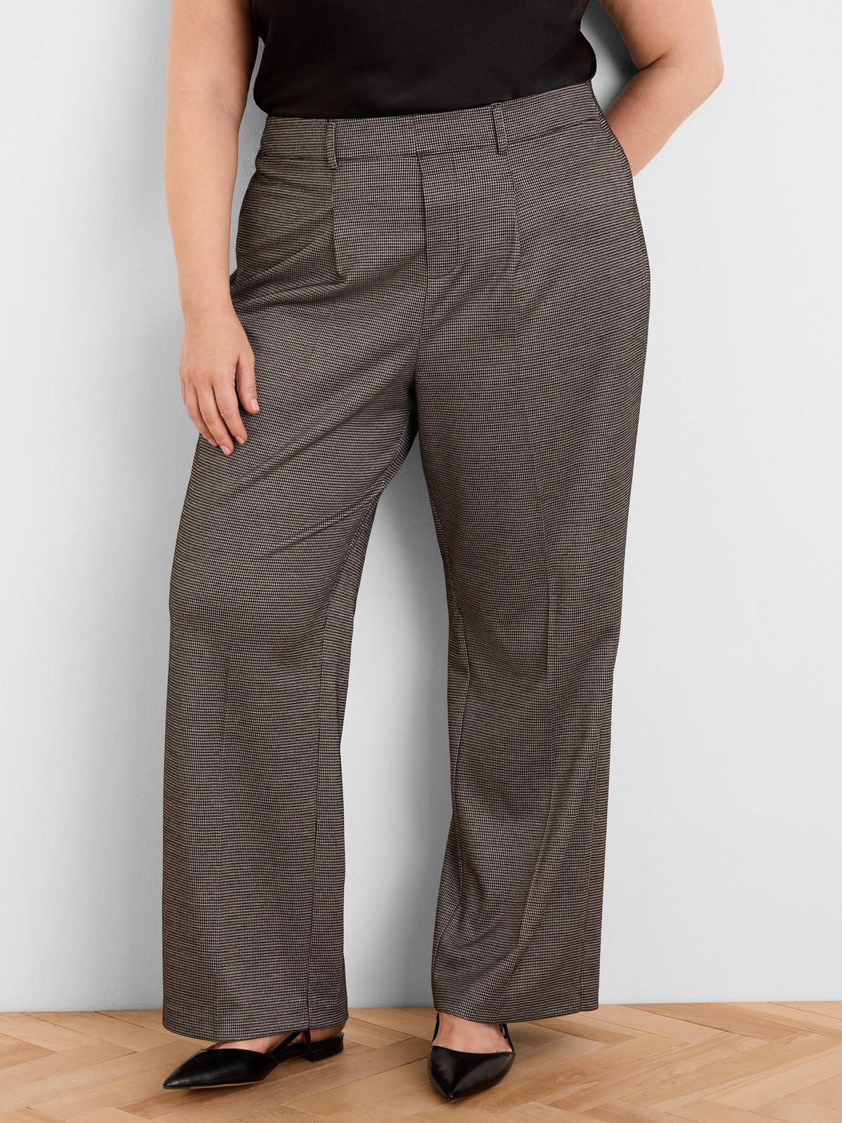 Brown and gold houndstooth tweed trousers with wide legs, front pleats, and belt loops.