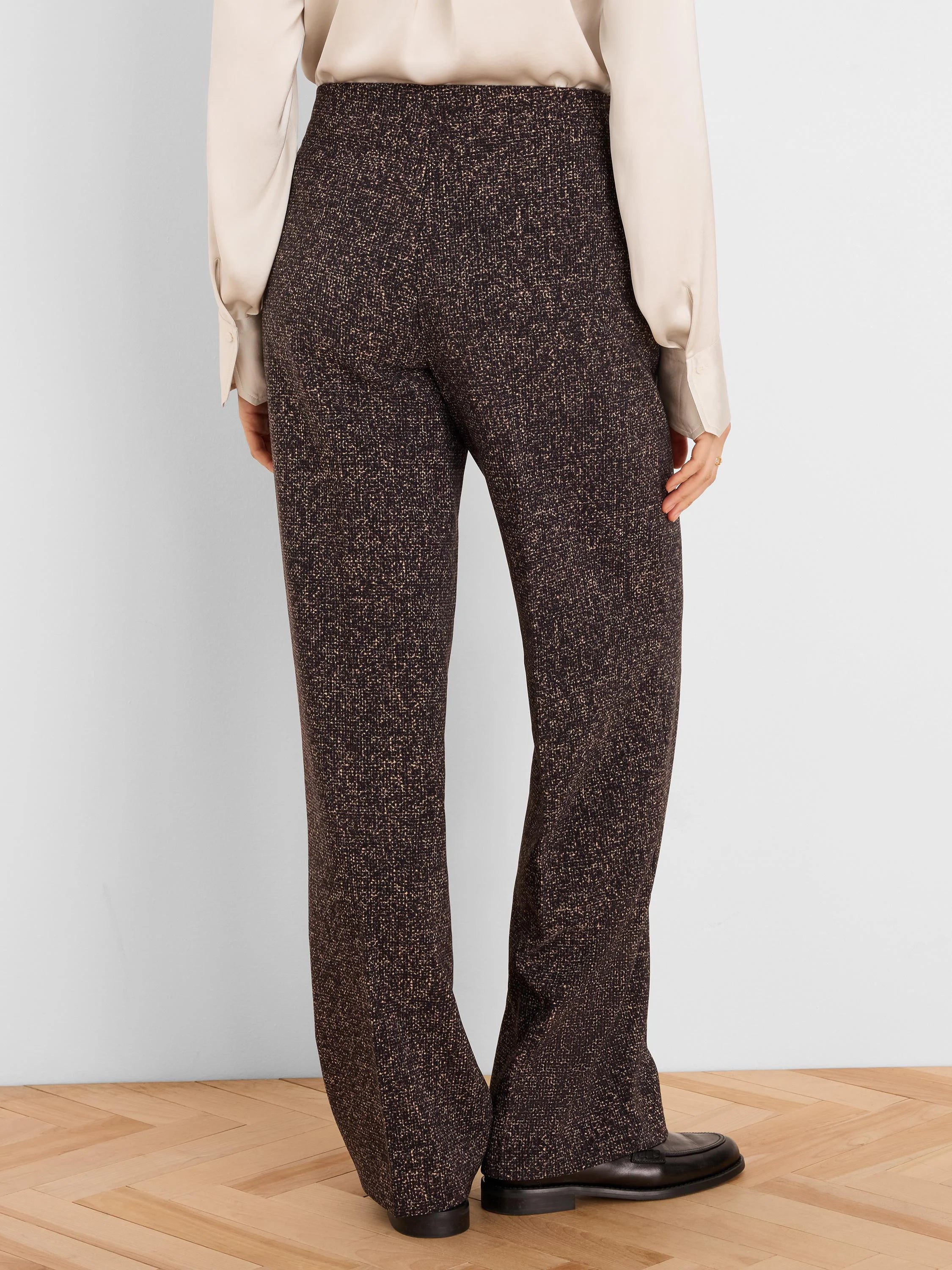 Dark brown wide-leg pants with a light speckled print, shown from the back with a high-waisted fit.