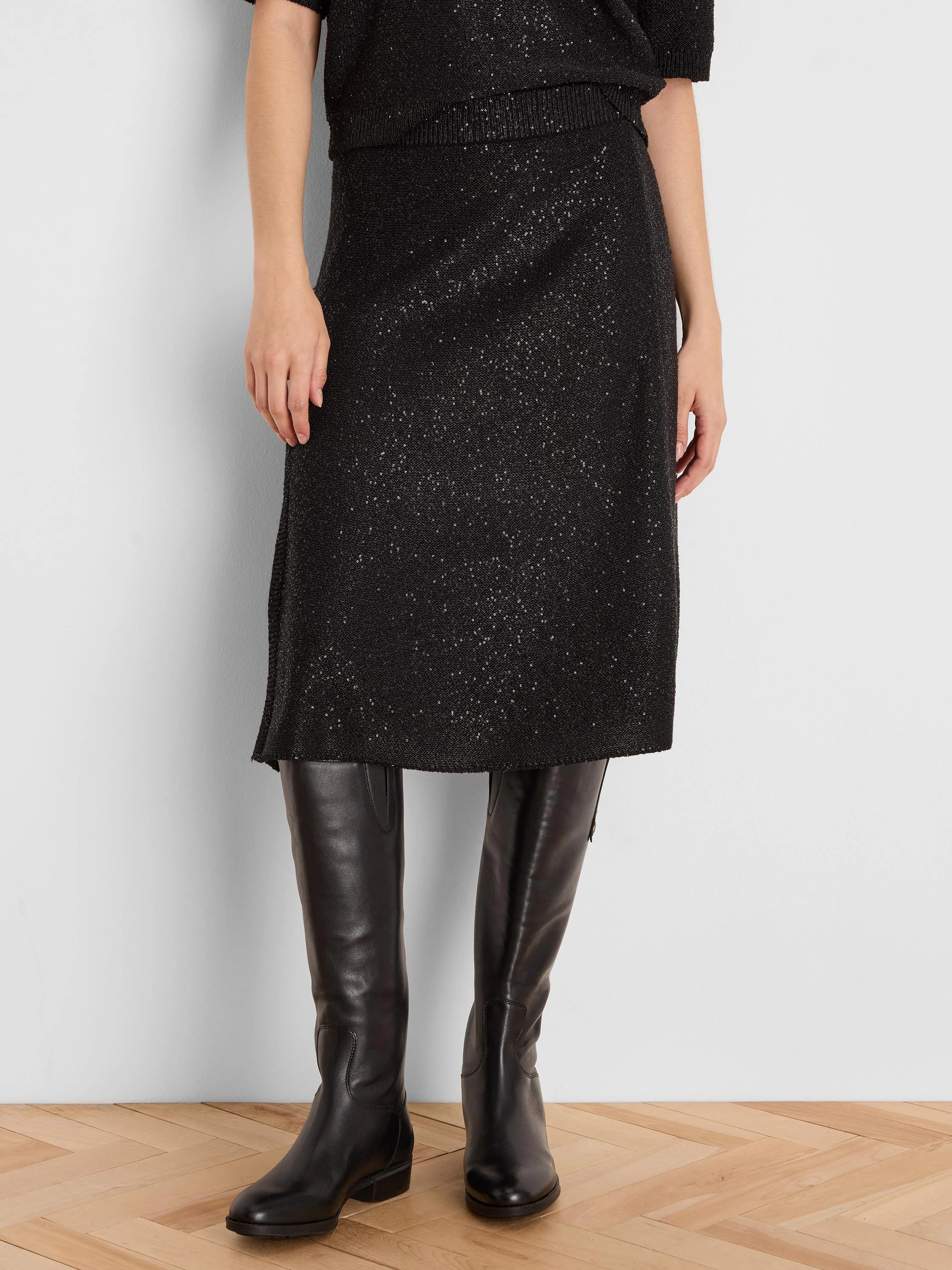 Black sequin knit skirt, straight cut, falls below the knee.