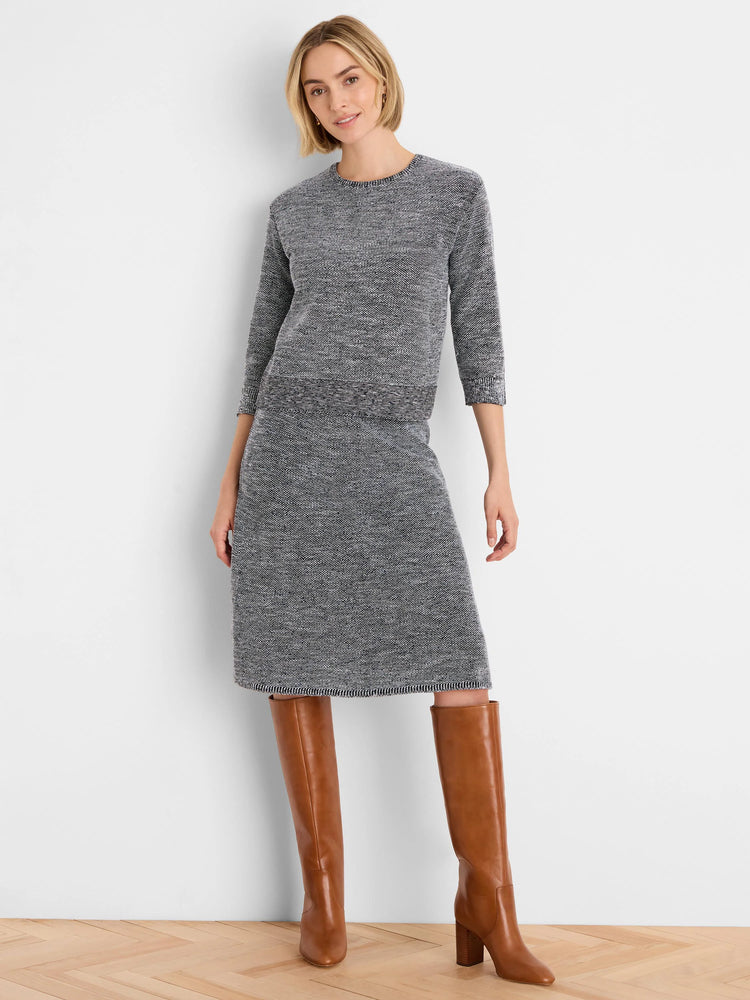 Black and white tweed stitch knit midi skirt with a ribbed hem.
