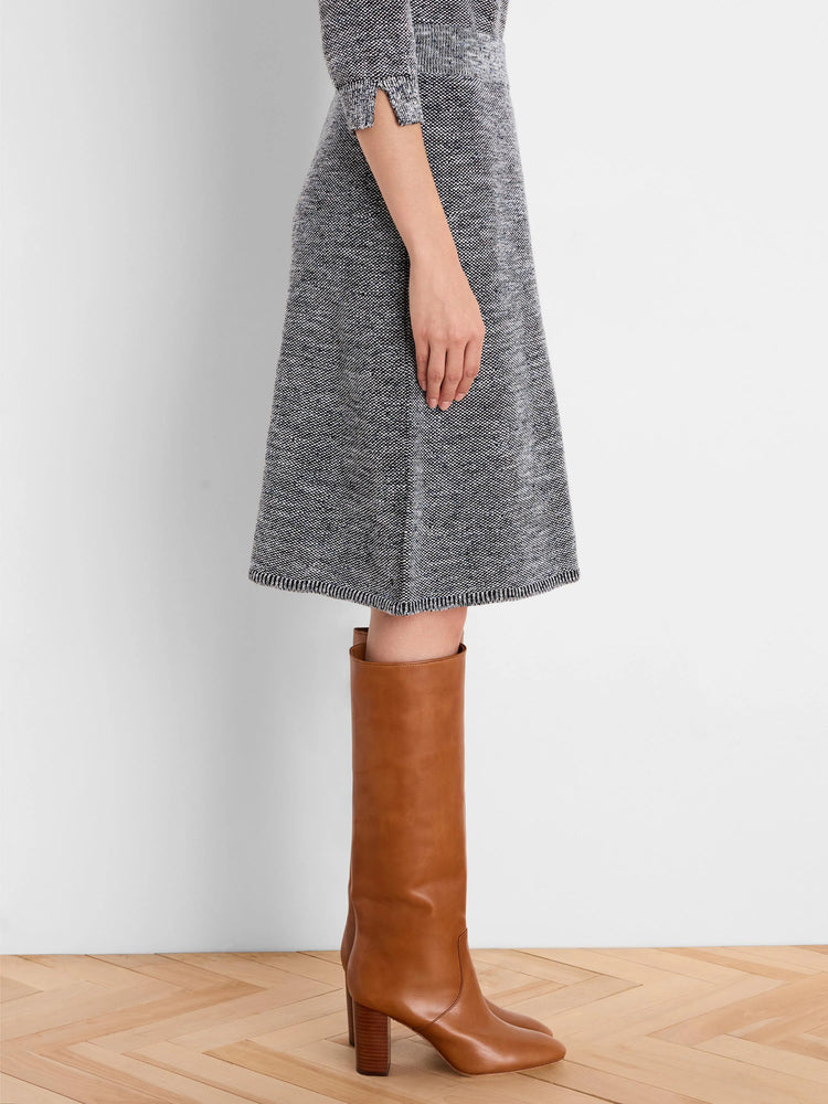 Knee-length A-line skirt with dark grey, white & blue tweed knit pattern and a ribbed hem.