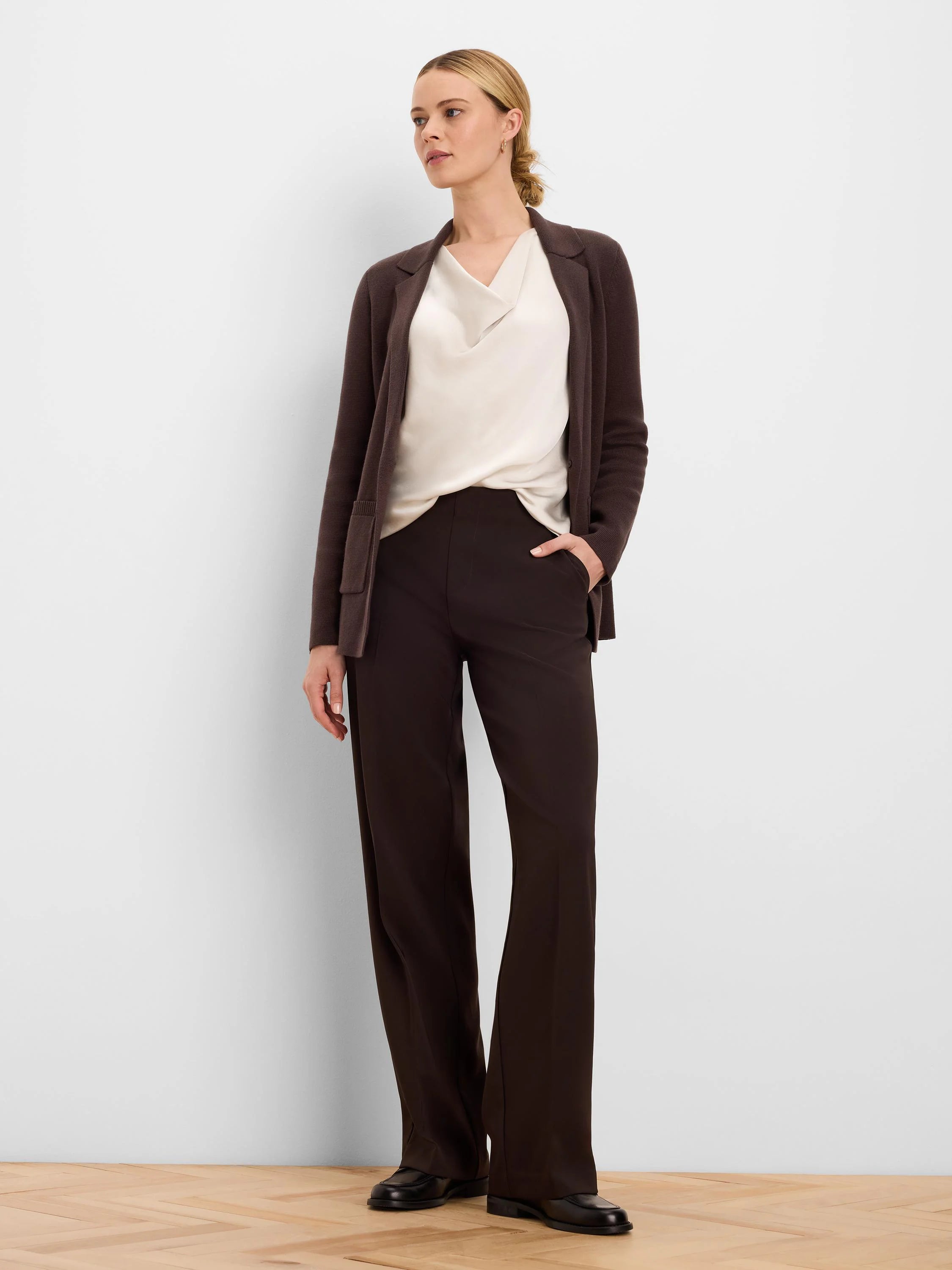 Dark brown, full-length wide-leg pants with a sleek, smooth texture.